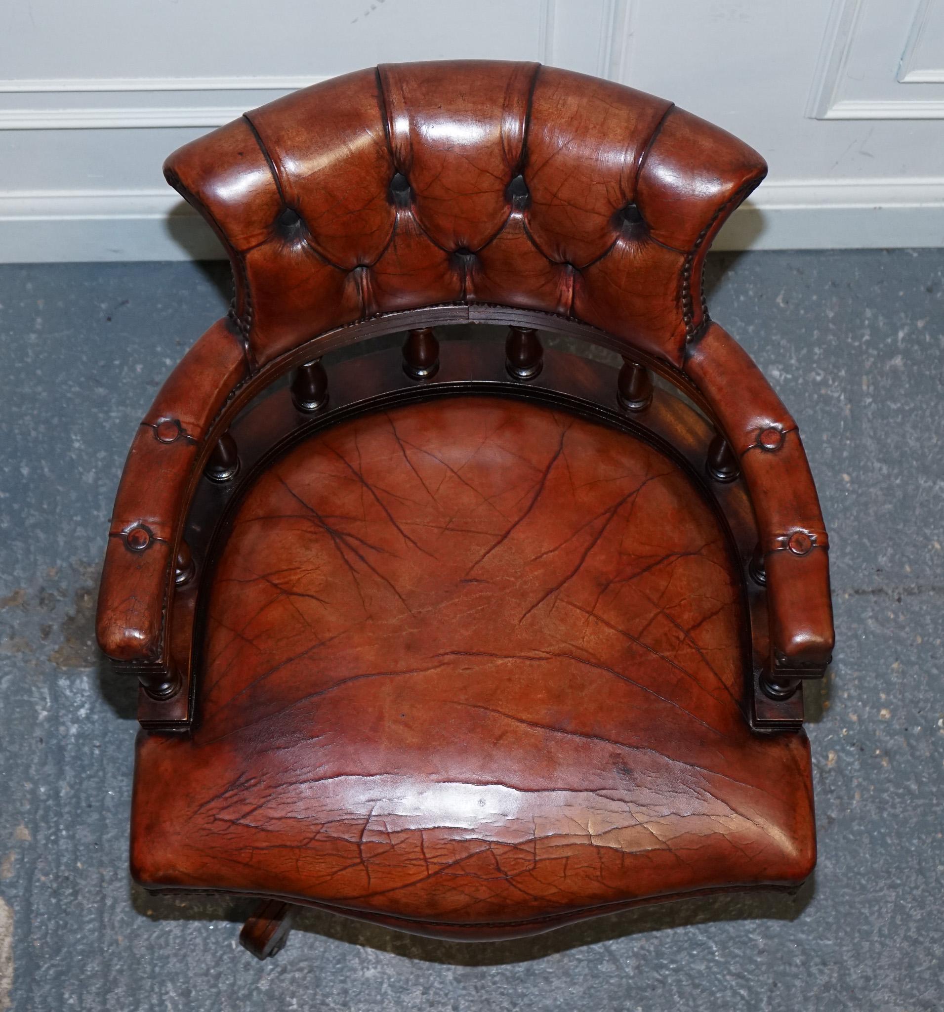 
We are delighted to offer for sale This exquisite antique hand-dyed brown leather Chesterfield captain's office swivel armchair is a stunning example of craftsmanship and timeless design. Its classic Chesterfield silhouette is characterized by deep