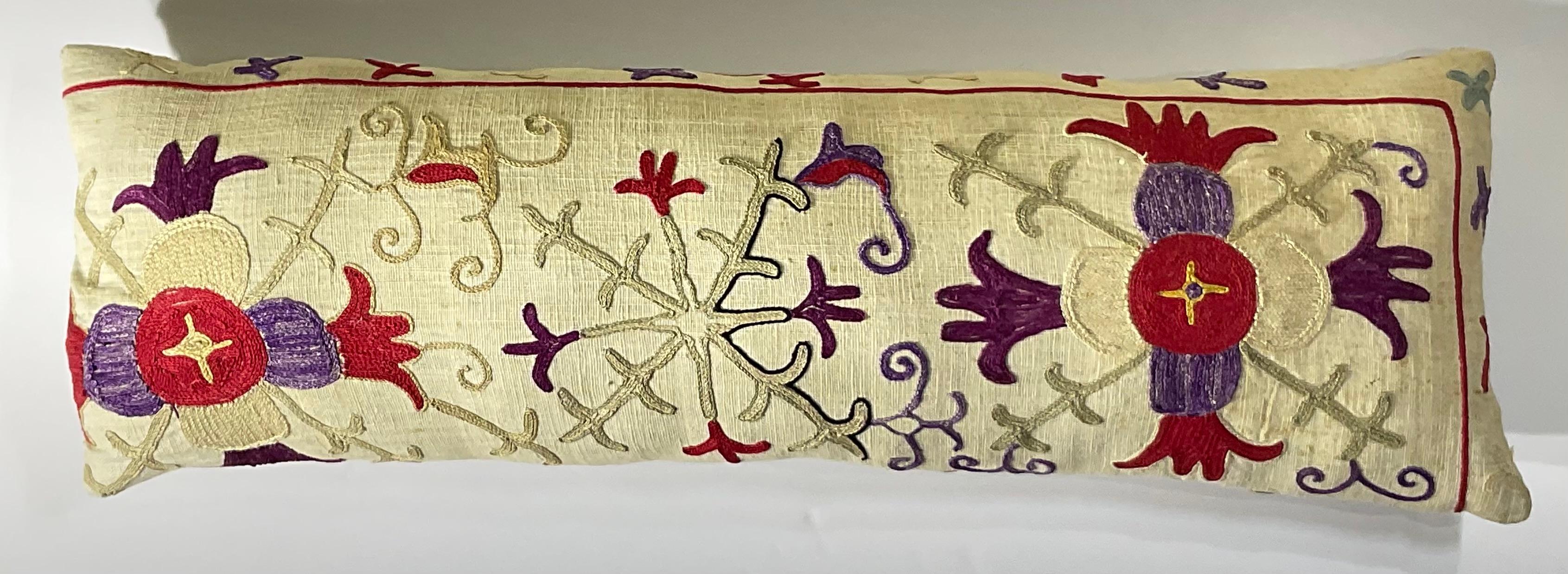 

This beautiful Suzani pillow is a true treasure, showcasing the artistry and craftsmanship of the past.  Hand embroidered with intricate floral and geometric motifs, this pillow is a testament to the skill and dedication of the artisans who