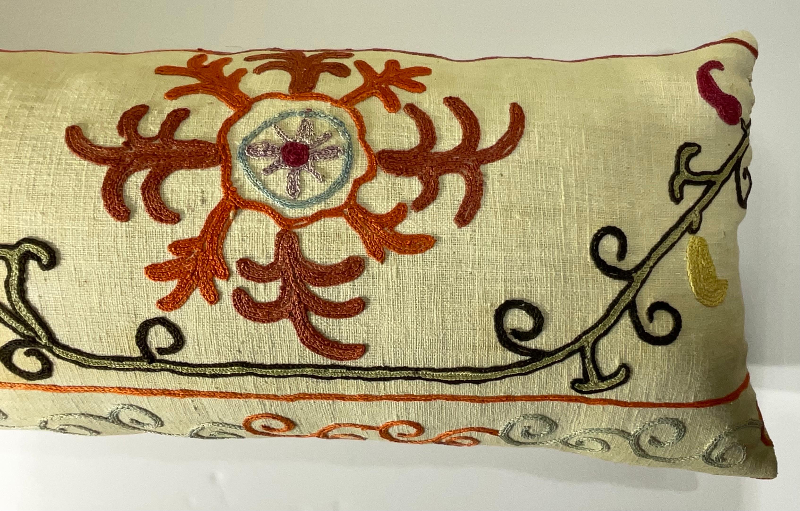 

This beautiful Suzani pillow is a true treasure, showcasing the artistry and craftsmanship of the past.  Hand embroidered with intricate floral and geometric motifs, this pillow is a testament to the skill and dedication of the artisans who