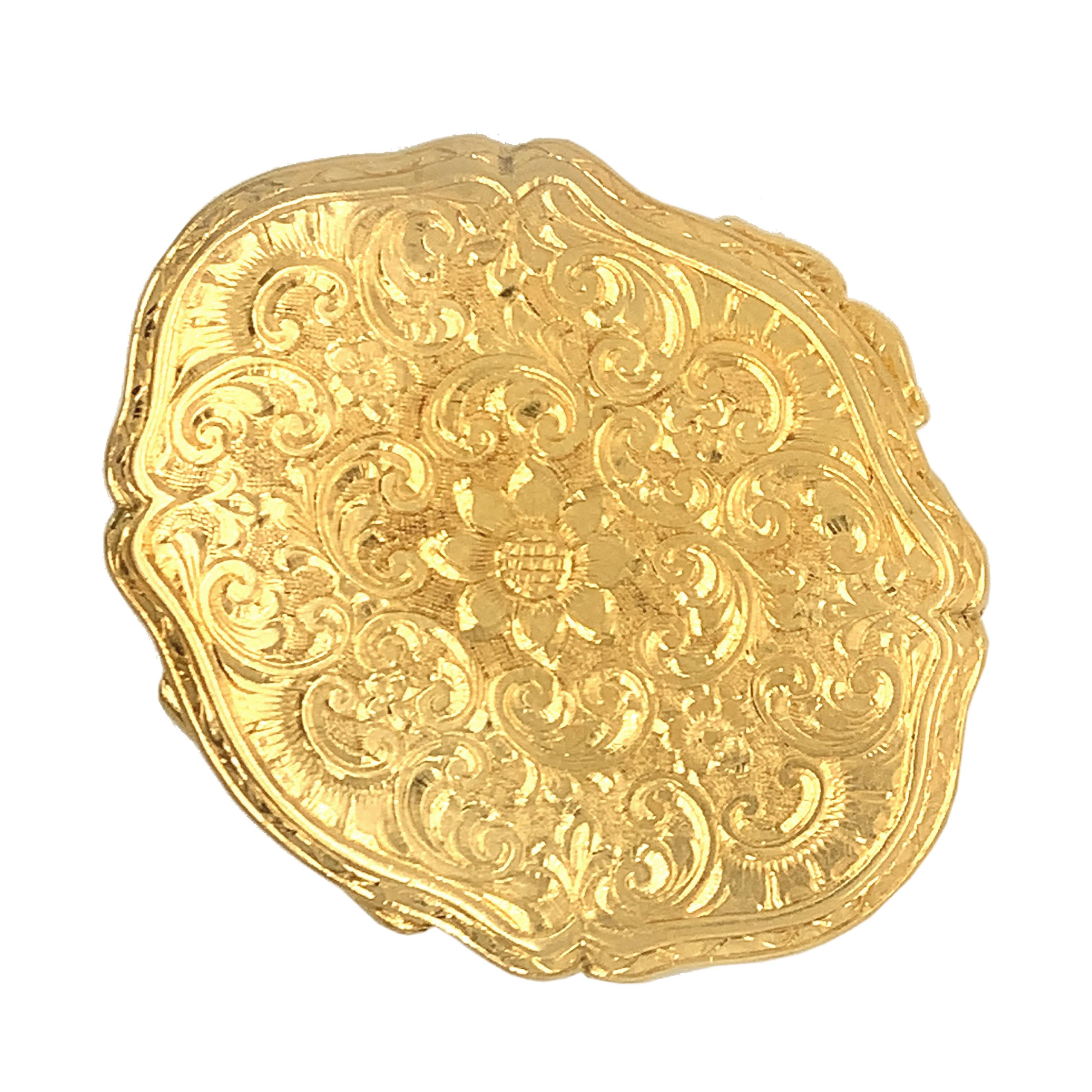 Beautifully detailed pill box with hand-engraving throughout. The careful faceting within the gold captures light at every angle, adding to its already luxurious fabrication. Meticulously hand engraved; a central figural flower radiates out into a