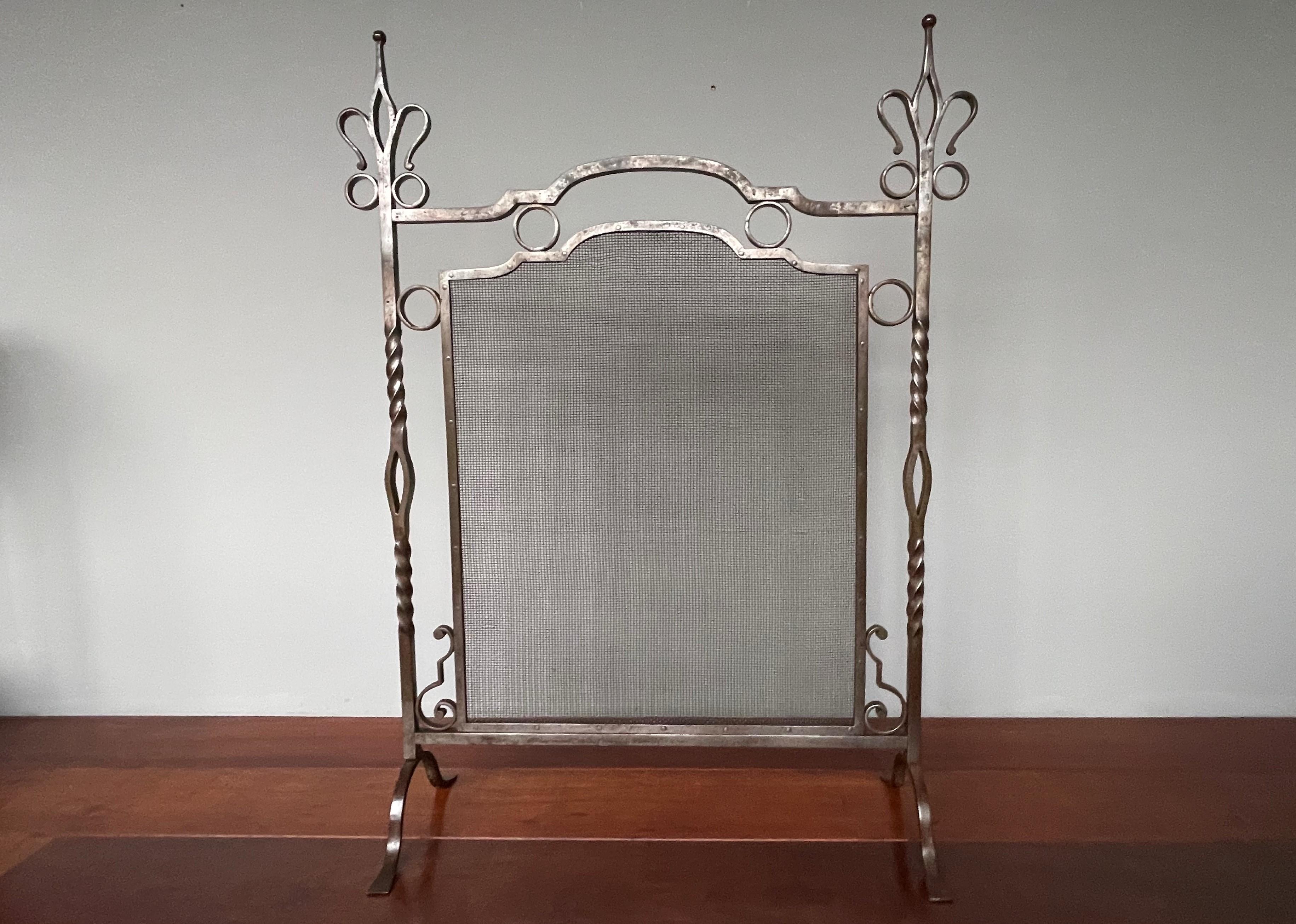 Stylish and incredibly durable, antique ironwork firescreen.

This good size and top quality workmanship firescreen dates from the European Arts and Crafts era and we were quite surprised not to find any maker's marks on it, because this is the type