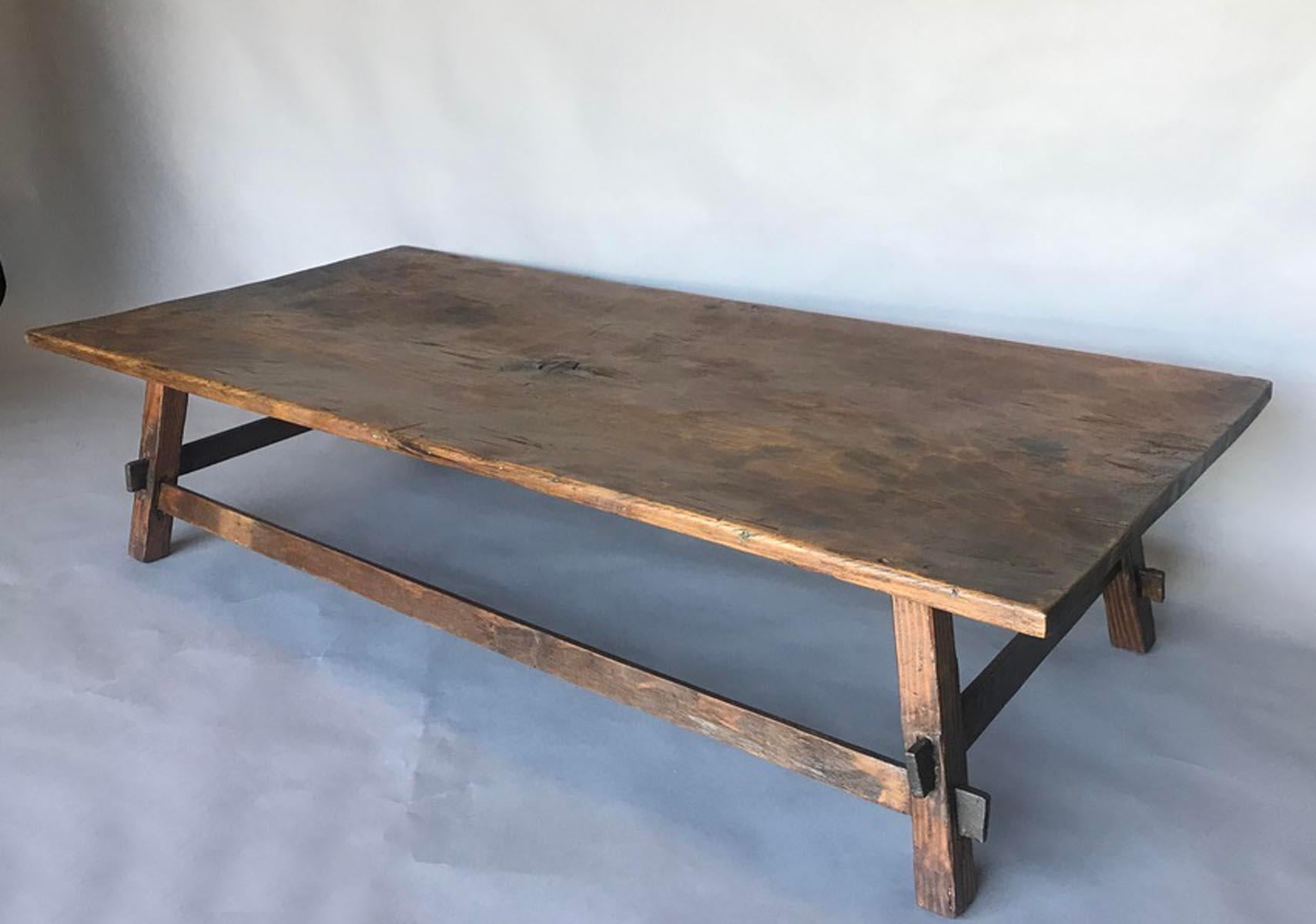 This table consists of a 19th century cedro, tropical hardwood, top and a newly constructed base. The top is one wide board top and hand hewn. The base is made from reclaimed wood and finished to match top. Table has gorgeous patina and a smooth