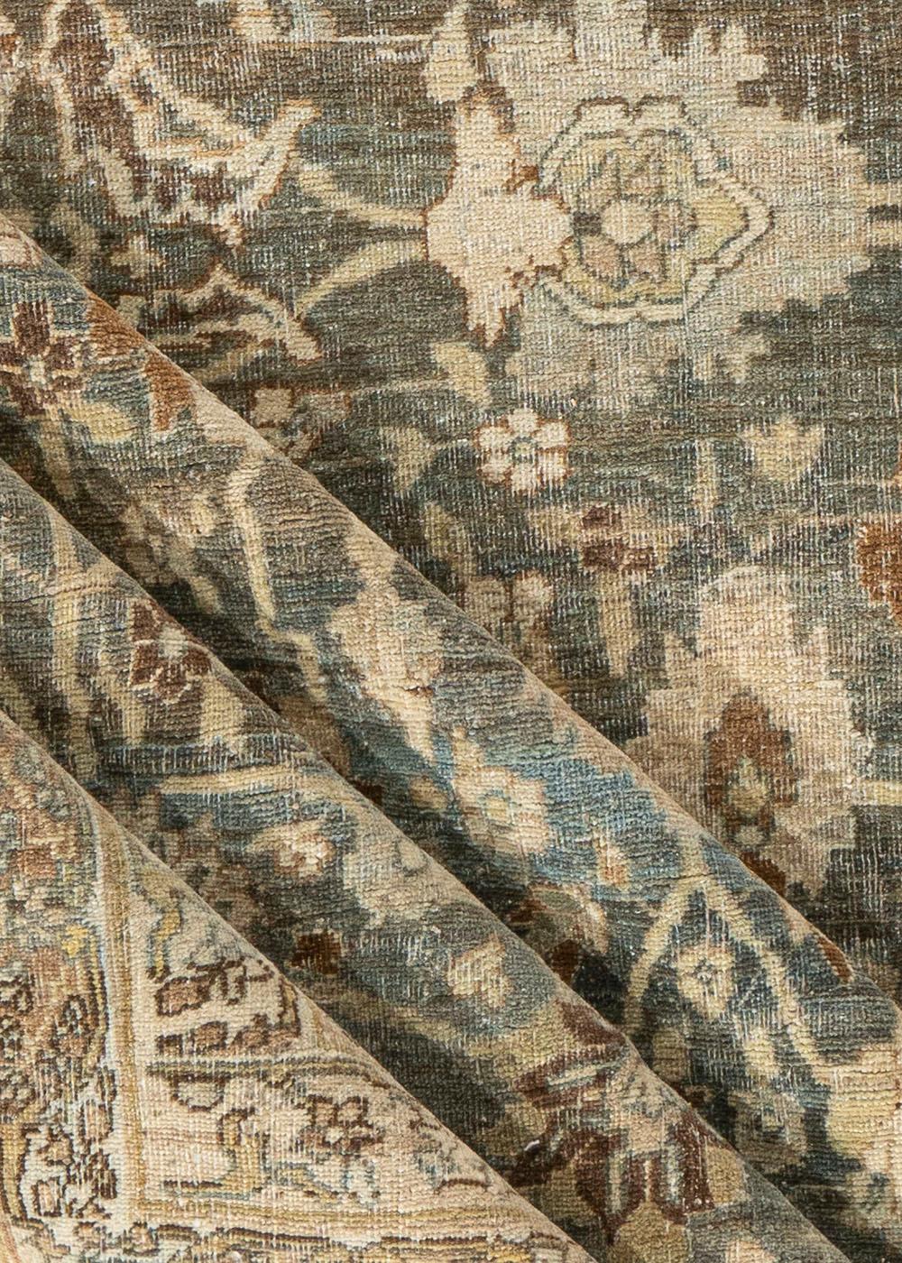 This grand Antique Persian Bidjar rug, measuring 12'1