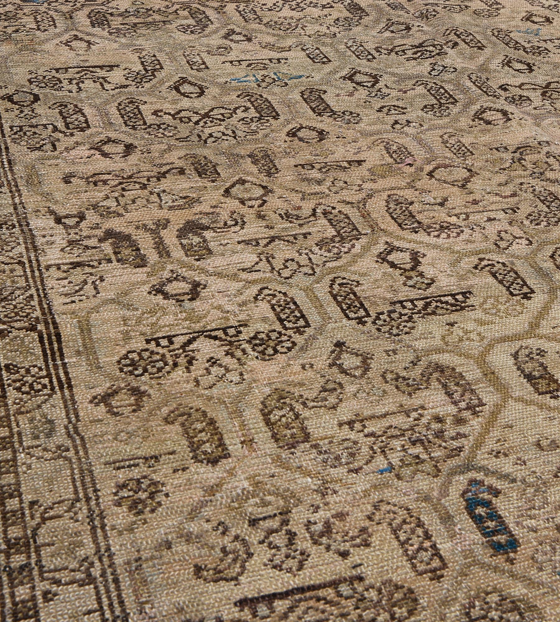 This antique Malayer rug has a buff-brown field with an overall design of diagonal rows light brown lozenges each containing a chocolate-brown central floral motif flanked by boteh and an angular flowerhead, in a triple striped buff-brown border