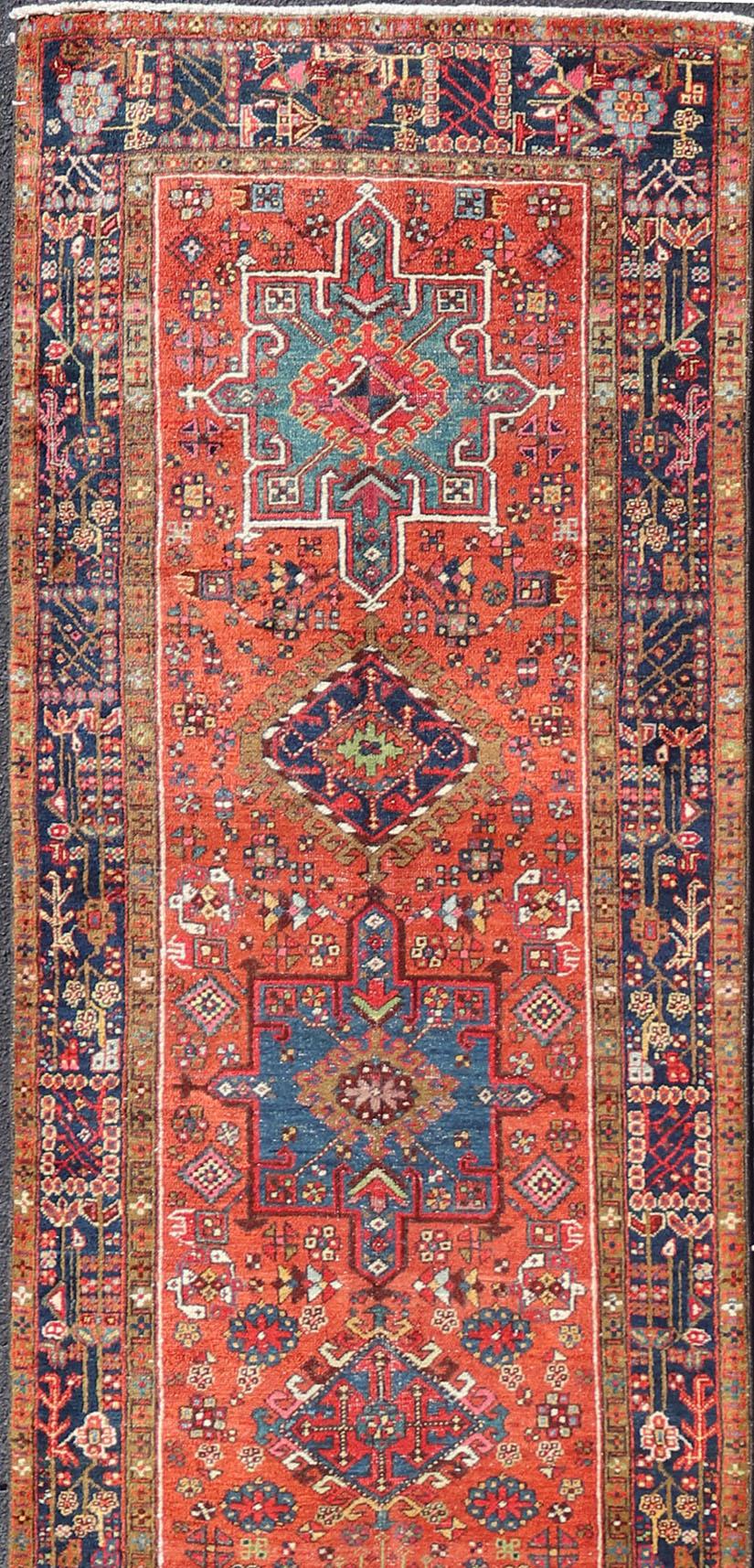 Very Long antique Persian Heriz runner with geometric medallion design in red, blue and colorful tones. Keivan Woven Arts / rug EMB-9560-P13076 , country of origin / type: Iran / Heriz, circa 1900

Measures:3'4 x 14'4.