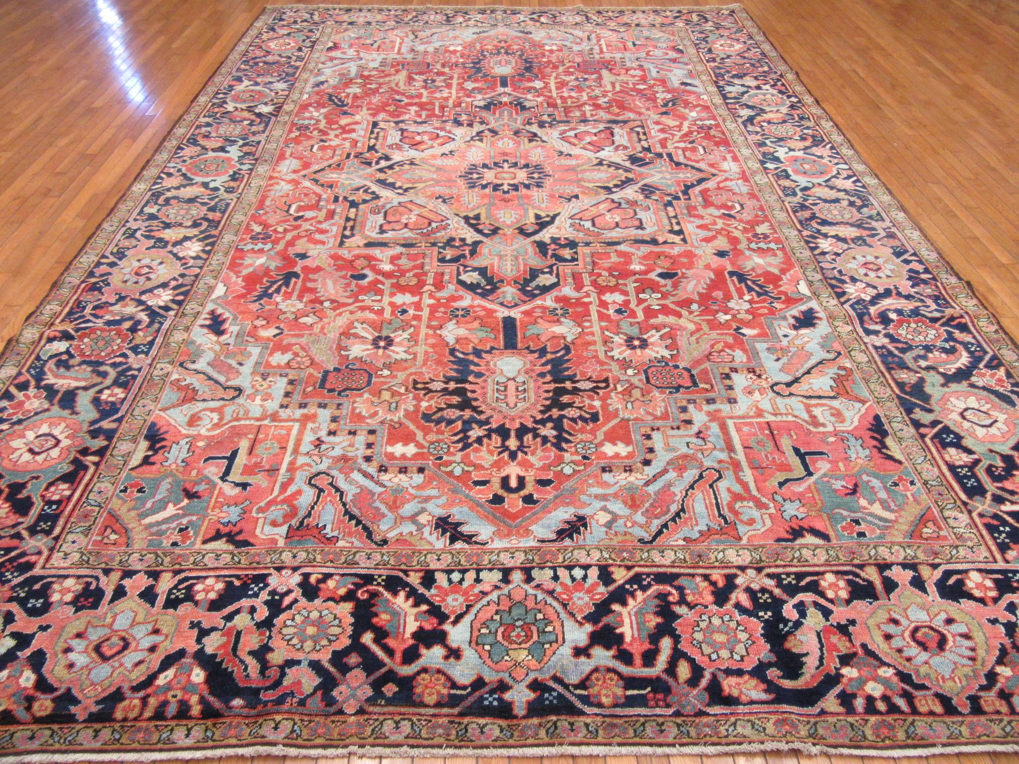 This is a large antique hand knotted rug from the Infamous village of Heriz in northwest of Iran (Persian).
This rug has the primary colors and geometric design made with wool and natural dyes. A very useful size for your home or office. It measure
