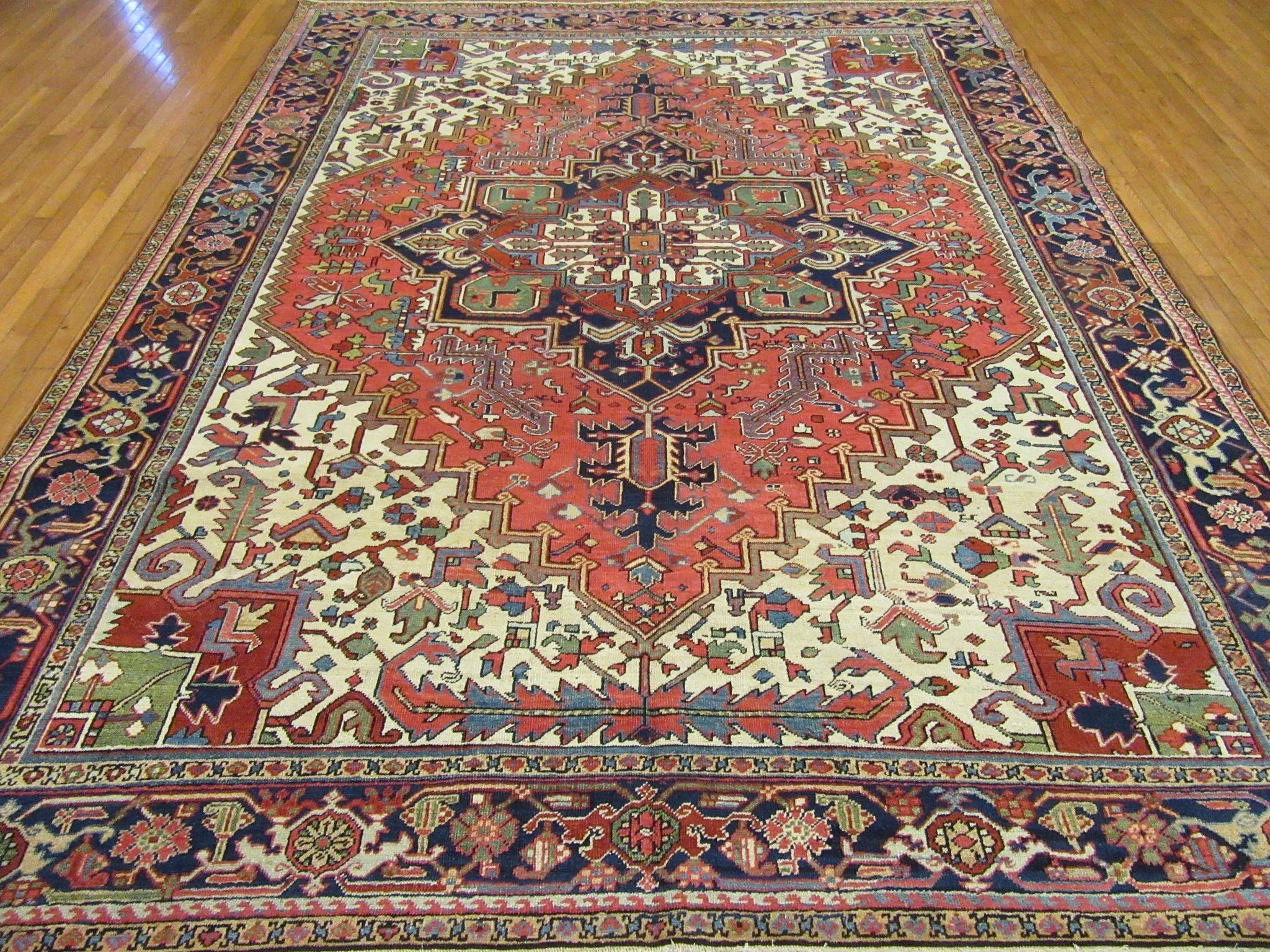 This is a large antique hand knotted rug from the Infamous village of Heriz in northwest of Iran (Persian).
This rug has the primary colors and geometric design made with wool and natural dyes. A very useful size for your home or office. It measure