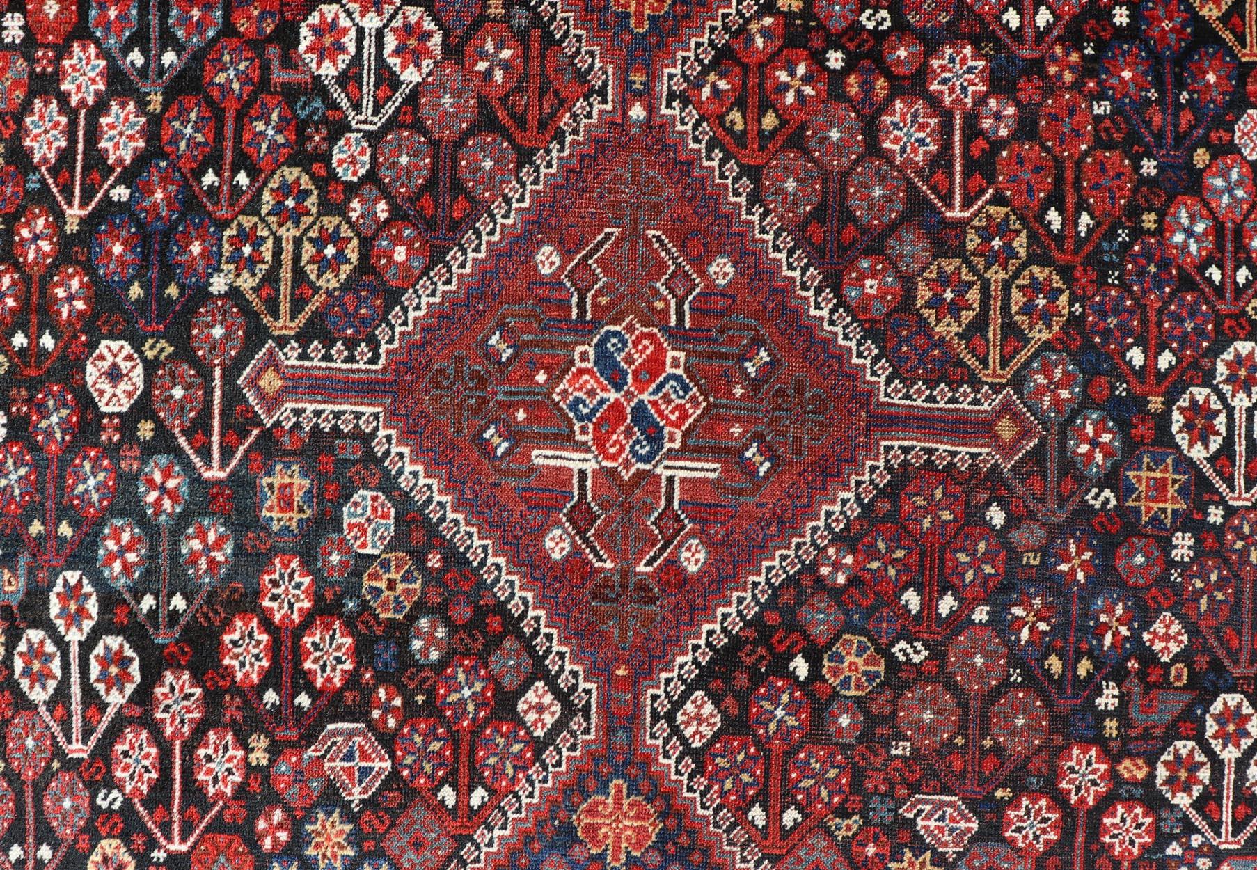 20th Century Antique Hand-Knotted Persian Qashqai Rug in Wool with All-Over Tribal Design For Sale