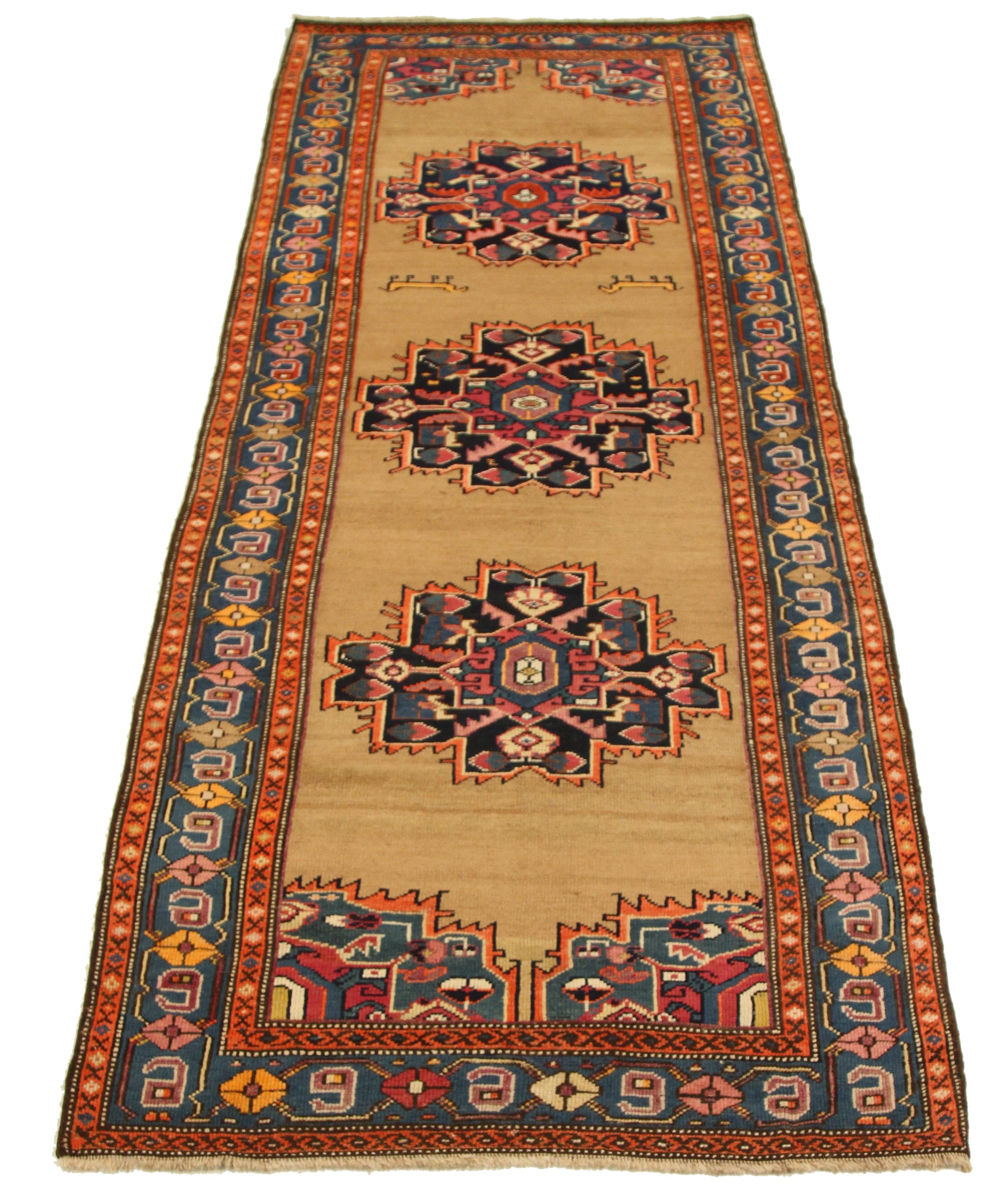 Antique handknotted Persian runner rug made from fine wool and all-natural vegetable dyes that are safe for people and pets. This beautiful piece features a rich field of floral details in various colors which is the traditional weaving design of
