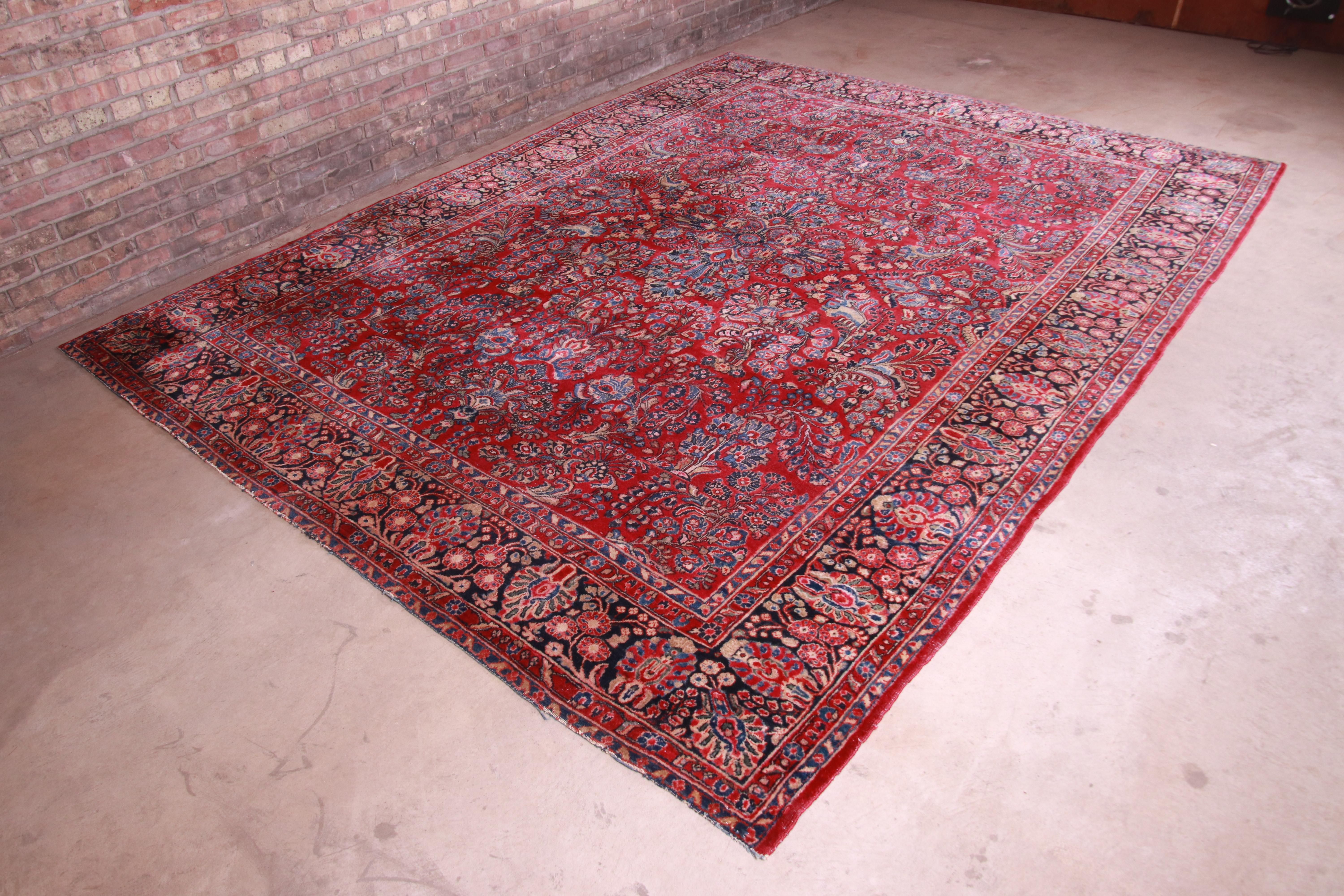 A gorgeous antique hand knotted Persian Sarouk room size rug

Persia, circa 1930s

Classic design with floral sprays and bouquets

Measures: 8