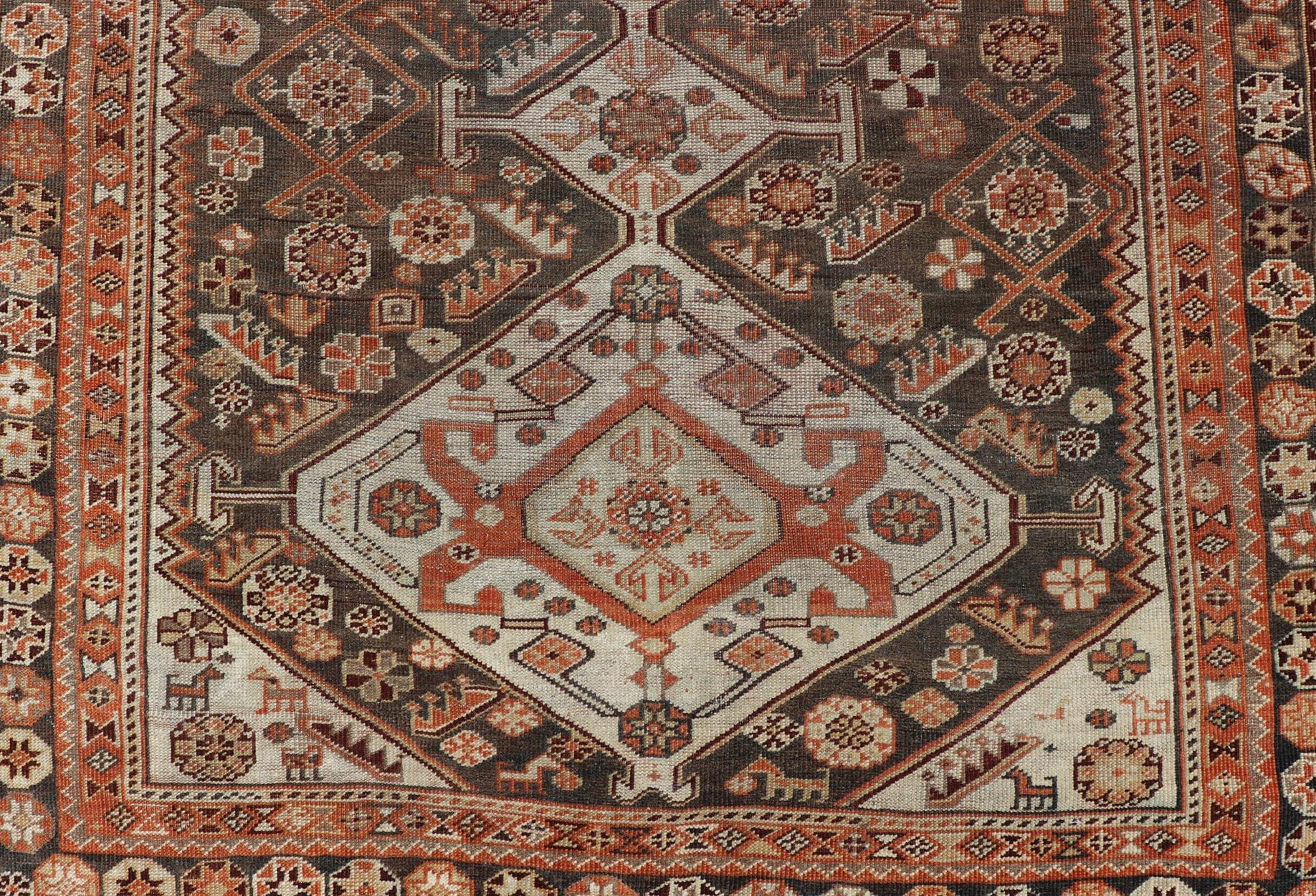 Measures: 3'6 x 6'1.
This antique Persian Shiraz rug has been hand-knotted in wool and features an all-over sub-geometric design rendered in multicolor. A complementary, multi-tiered border encompasses the entirety of the piece; making it a
