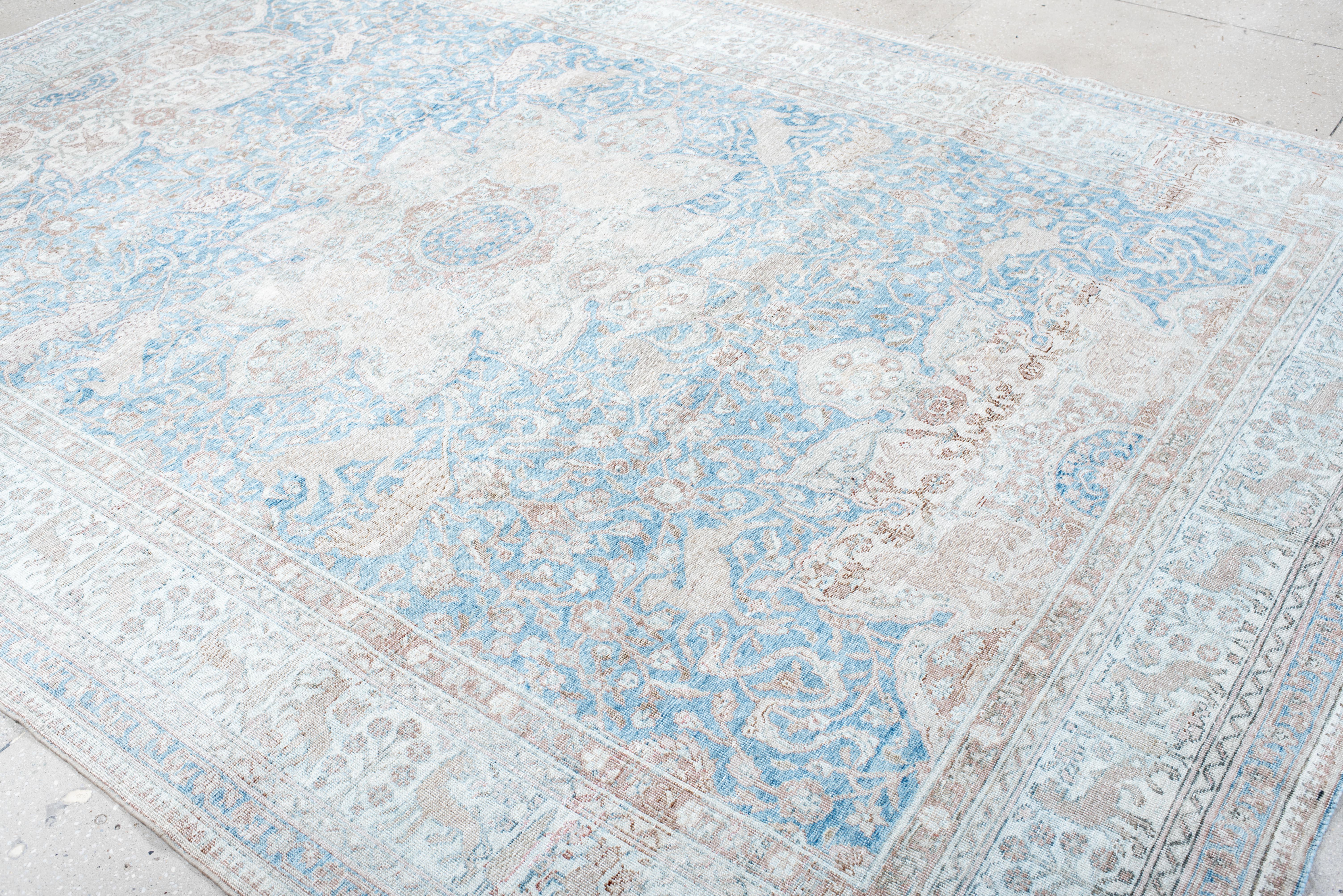 Ce tapis ancien de Sivas présente un élégant motif floral en médaillon d'inspiration ottomane, avec un jeu délicat de bleus doux, d'ivoire et de taupes terreux. Le champ orné est décoré de motifs botaniques complexes, gracieusement tissés pour créer