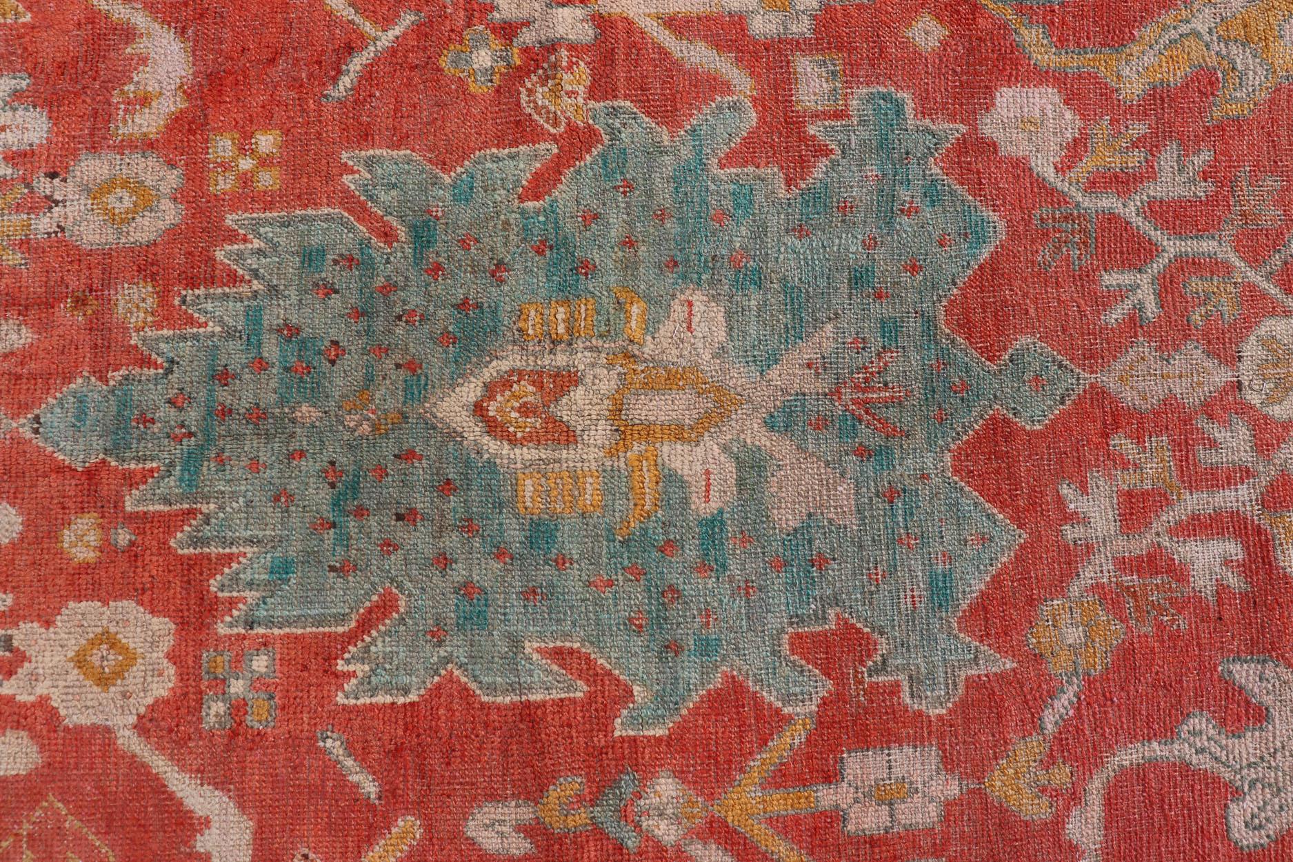 Antique Turkish Oushak rug with tribal Medallion design in terracotta, blue, cream, and marigold. Keivan Woven Arts / rug / 17-1108-K-105, country of origin / type: Turkey / Oushak, circa 1900
Measures: 9'7 x 14'9
This beautiful 19th century Oushak,