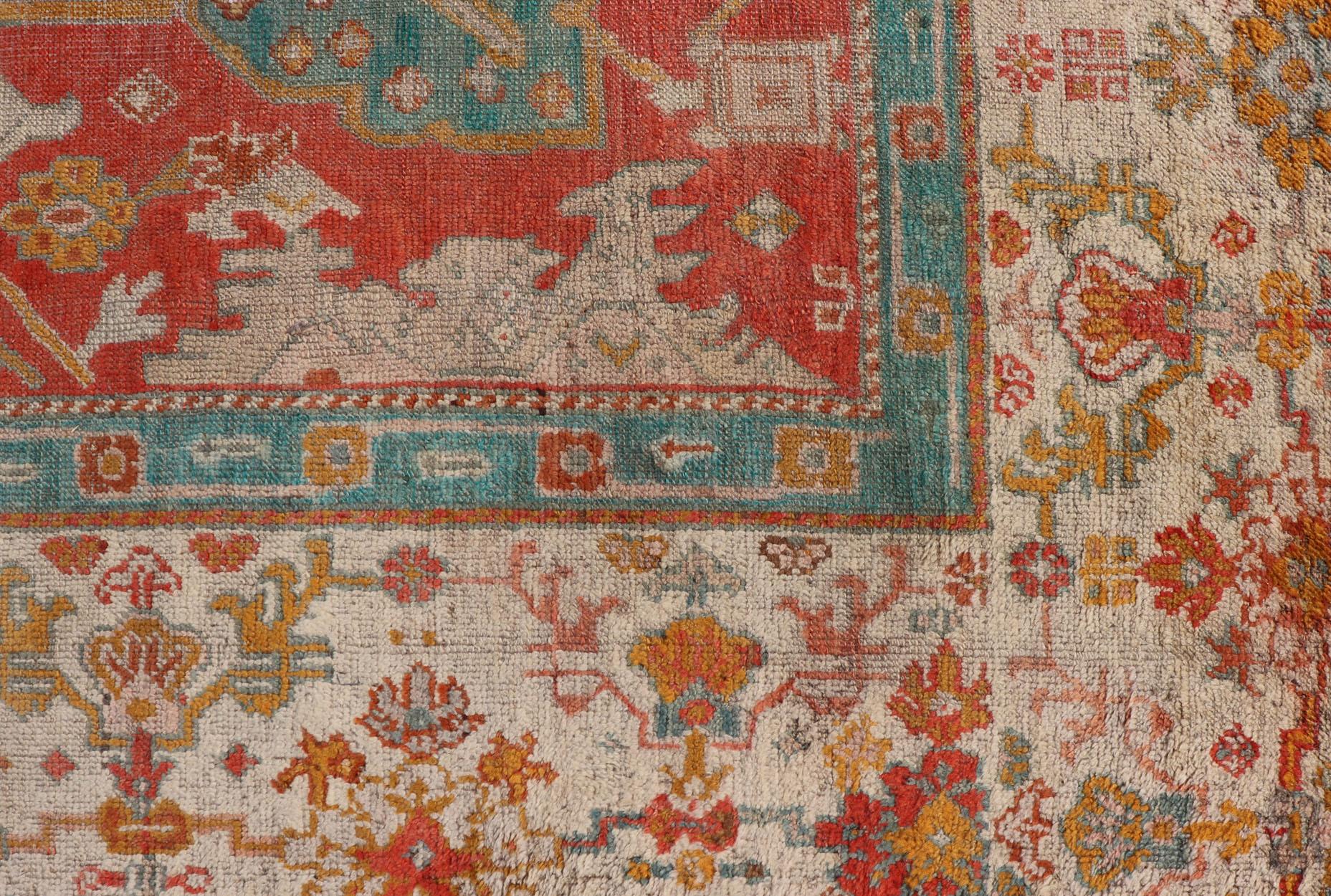 Antique Turkish Oushak In Tribal Motifs in Soft Coral, Blue, Marigold, and Cream In Good Condition For Sale In Atlanta, GA