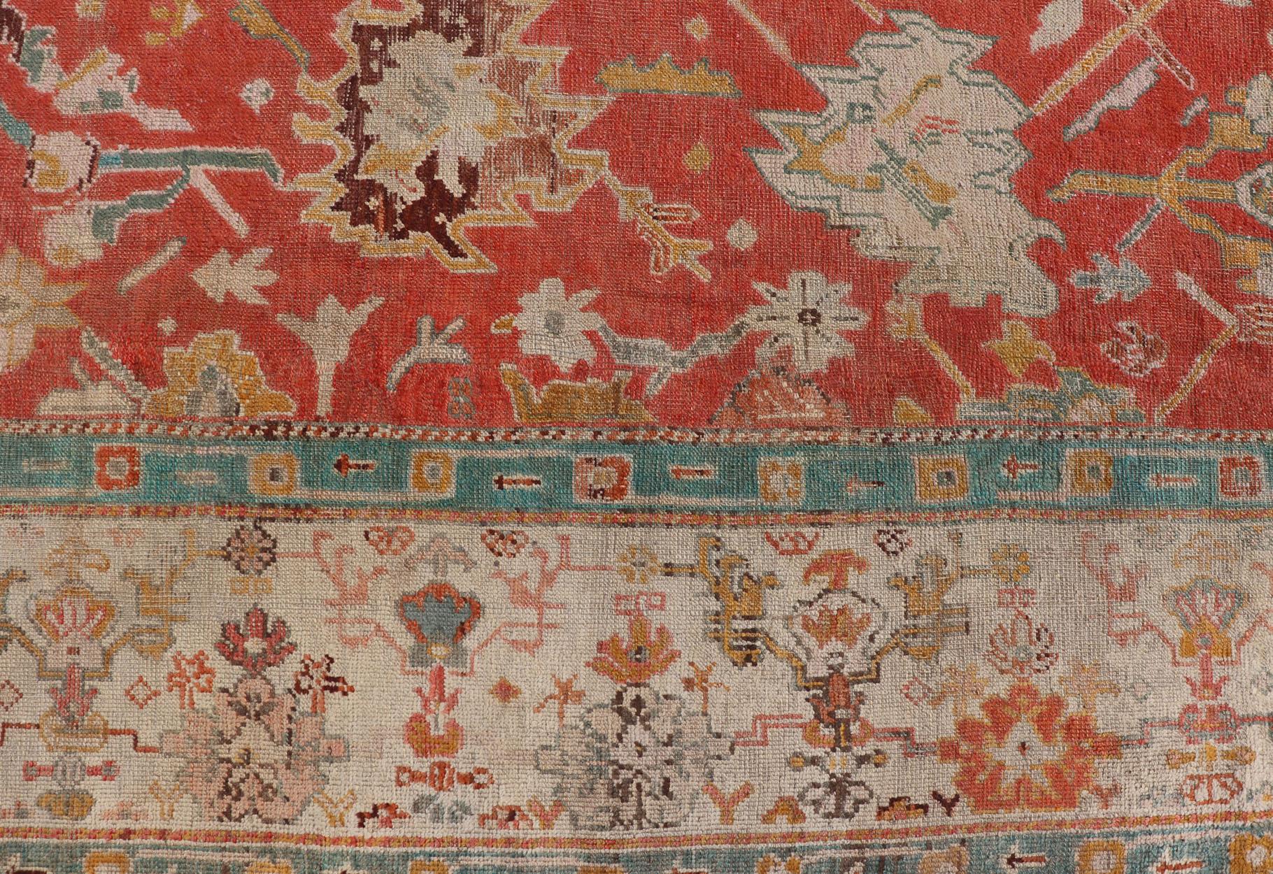 20th Century Antique Turkish Oushak In Tribal Motifs in Soft Coral, Blue, Marigold, and Cream For Sale