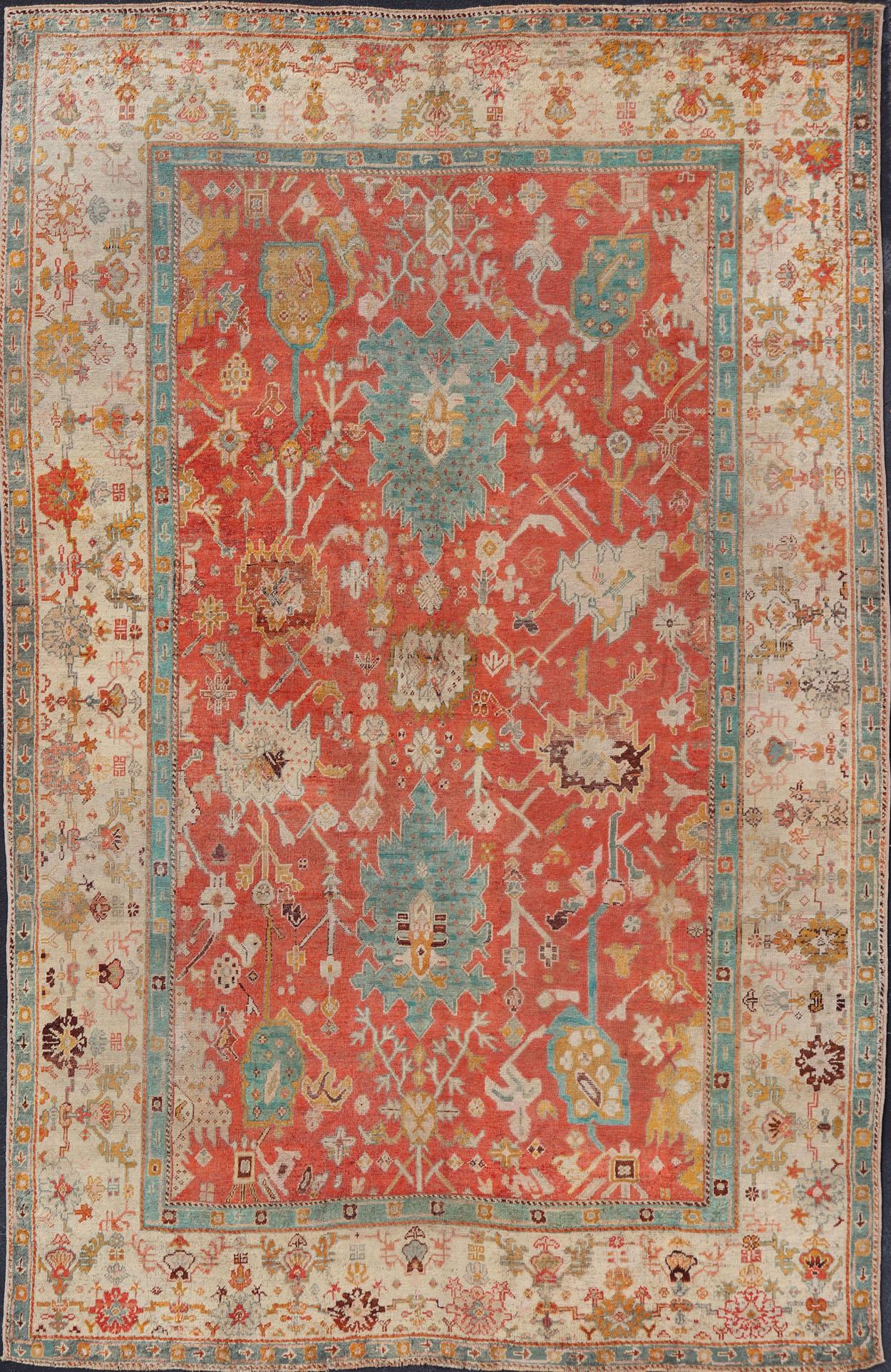Antique Turkish Oushak In Tribal Motifs in Soft Coral, Blue, Marigold, and Cream For Sale