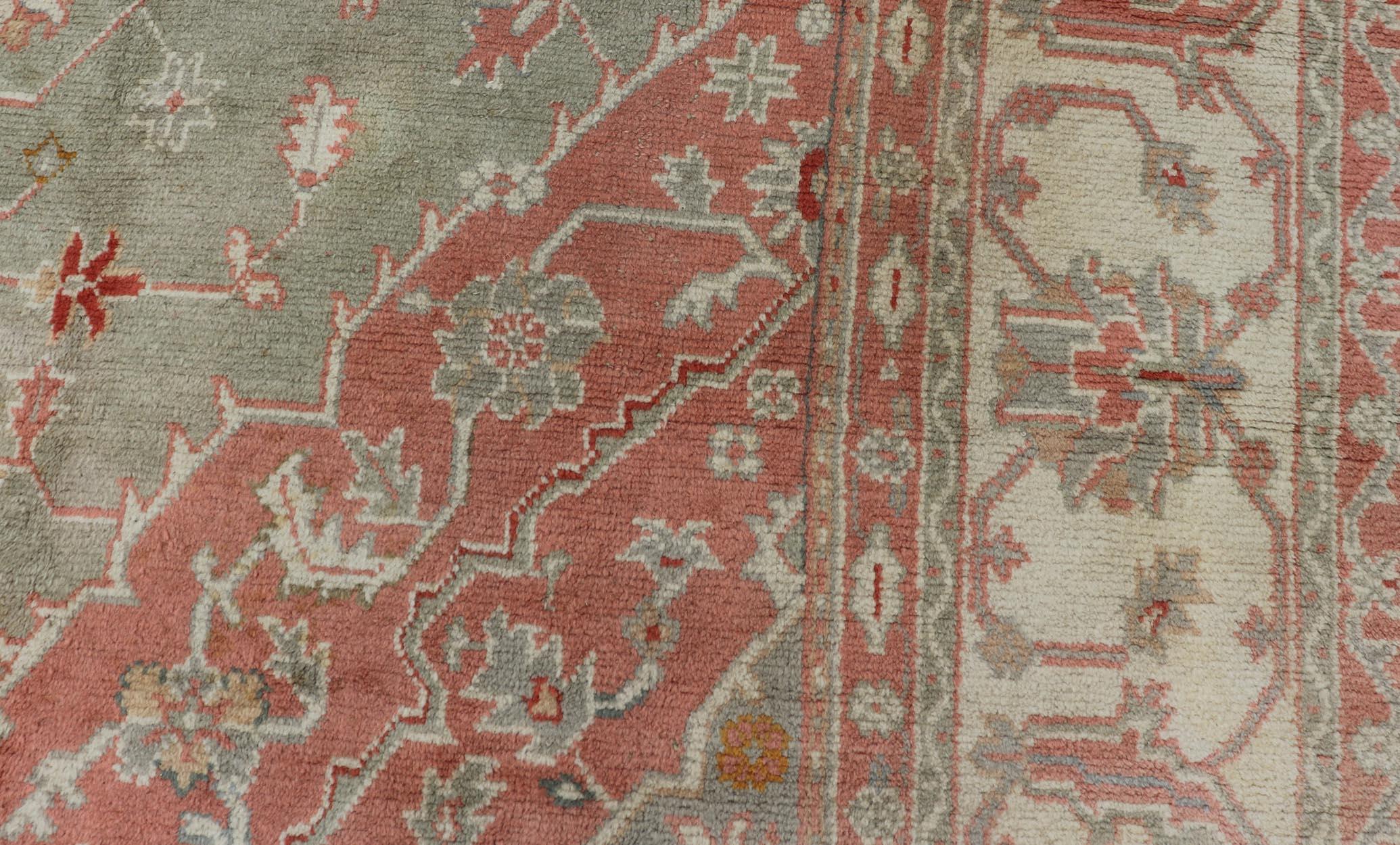 Antique Turkish Oushak rug with floral design in light green and soft pink. Keivan Woven Arts / rug 17-1101, country of origin / type: Turkey / Oushak, circa 1930. 
Measures: 13' x 16'1.
This large antique Turkish Oushak rug bears a light green