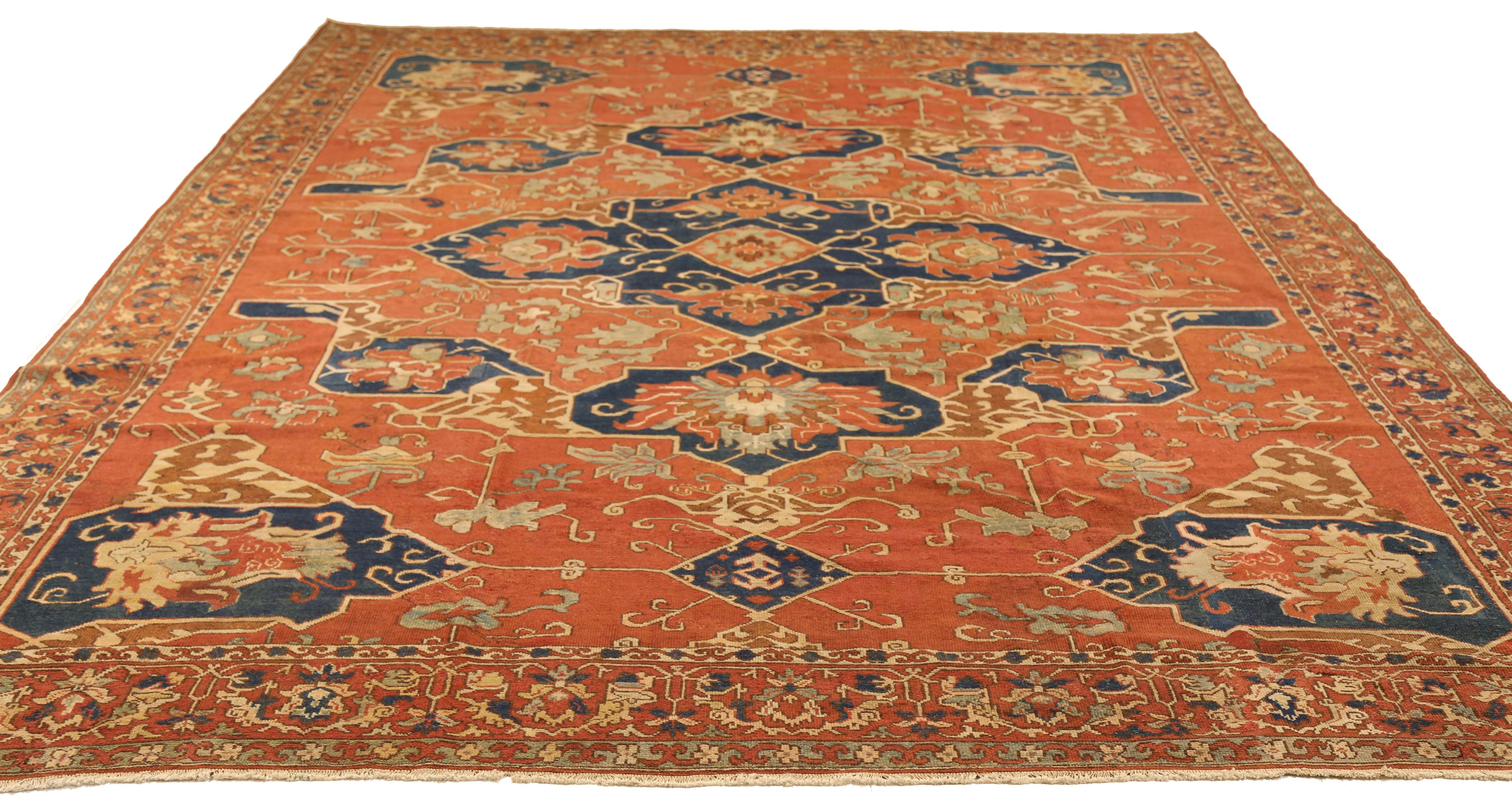 Antique hand knotted Turkish rug made from fine wool and all-natural vegetable dyes. This elegant piece features floral design patterns woven in traditional Heriz style that originated in ancient Persia. The color way offers a rustic look with the