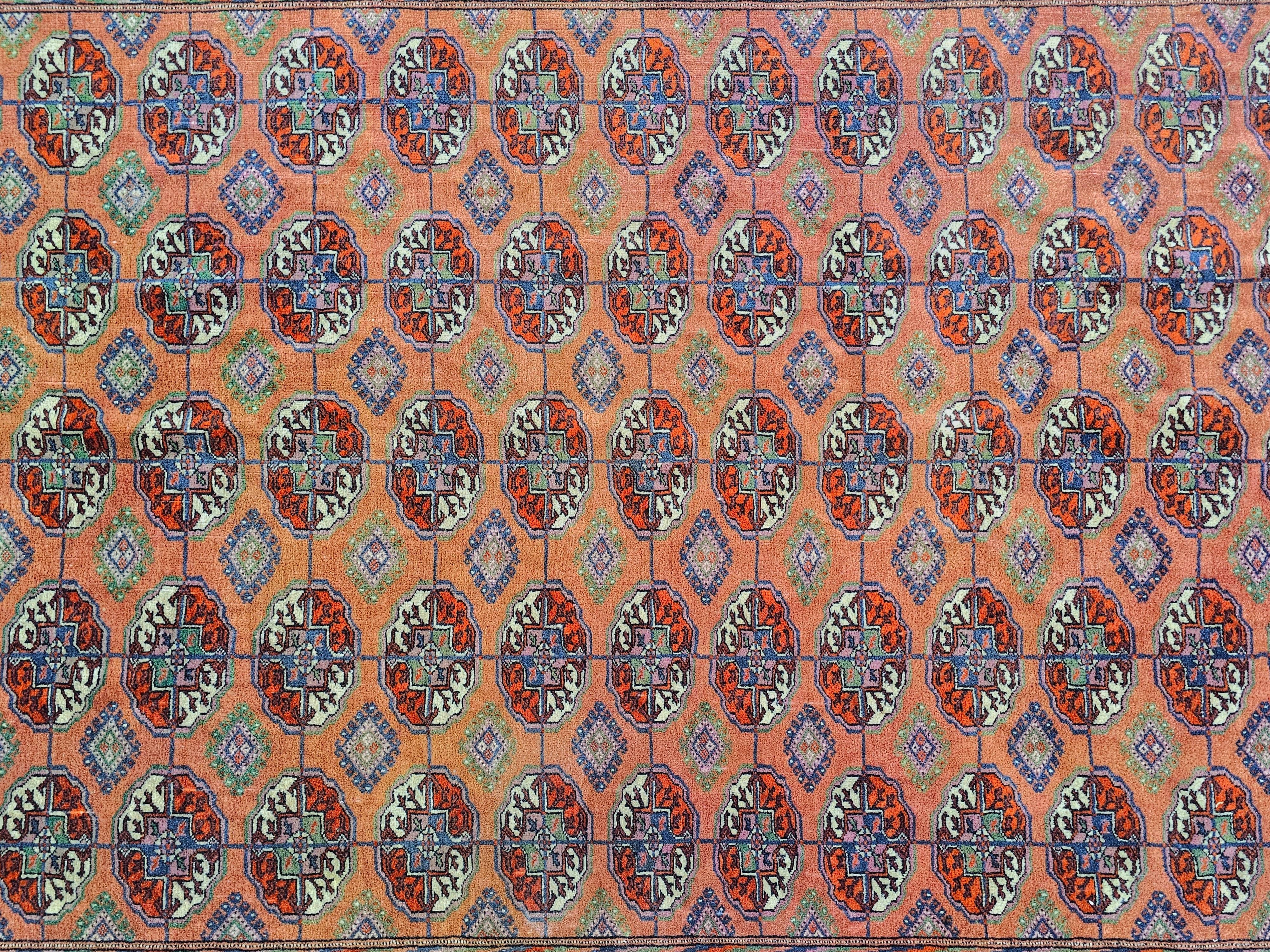 Wool Antique Hand-knotted Turkmen Bokhara Rug in brick orange/red, Turkmenistan 1920s