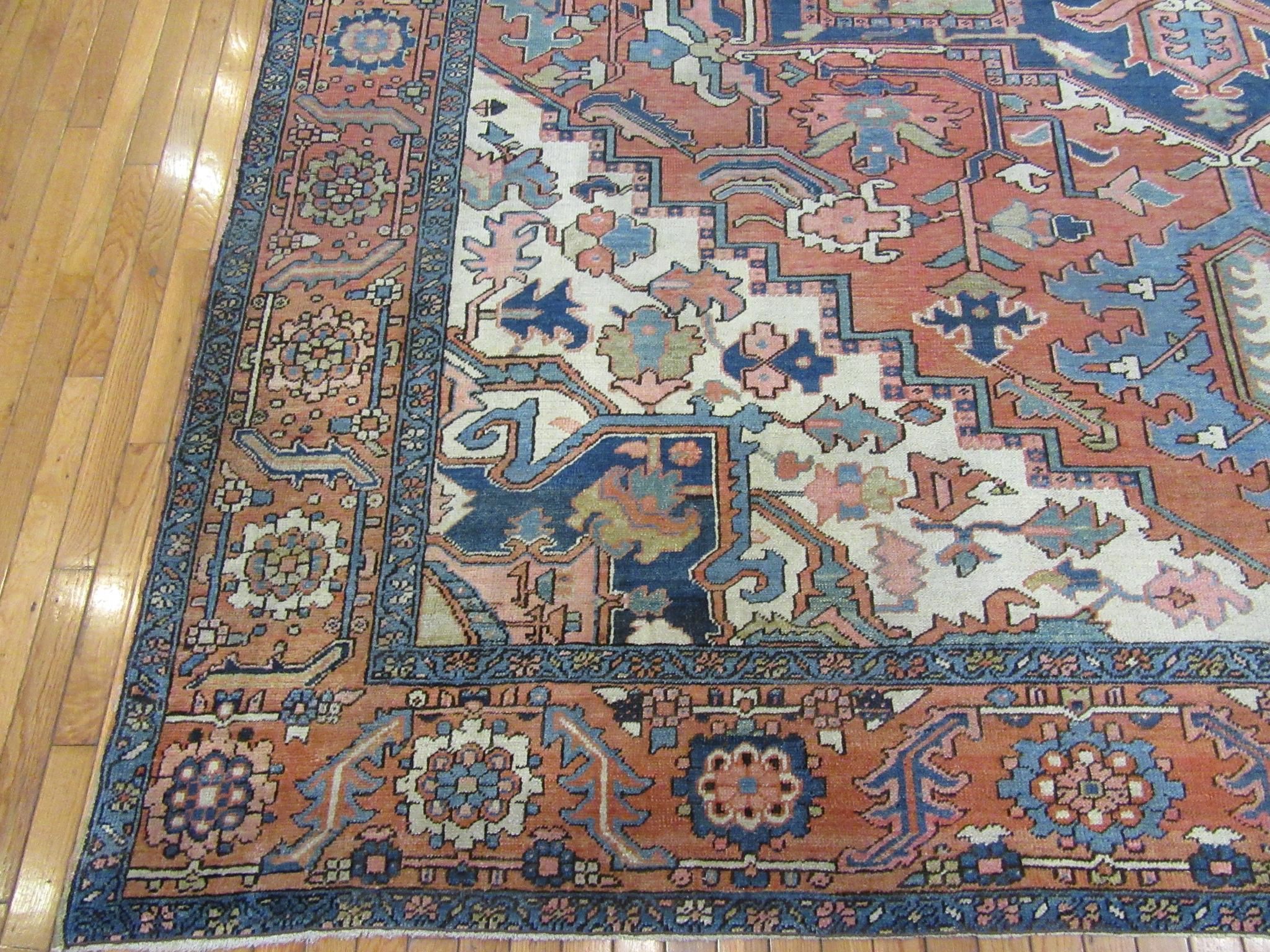 Hand-Knotted Antique Hand Knotted Wool Red and Blue Persian Serapi Rug For Sale