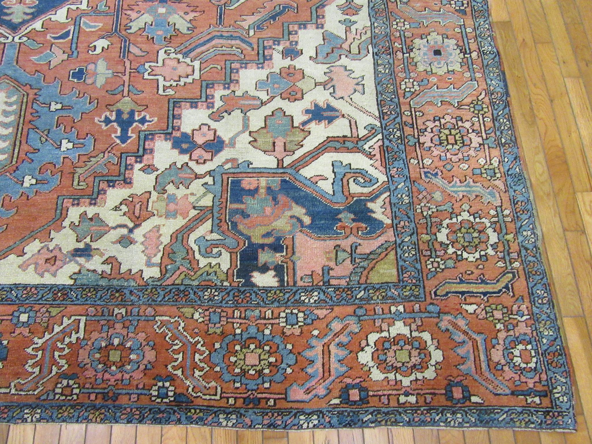 20th Century Antique Hand Knotted Wool Red and Blue Persian Serapi Rug For Sale