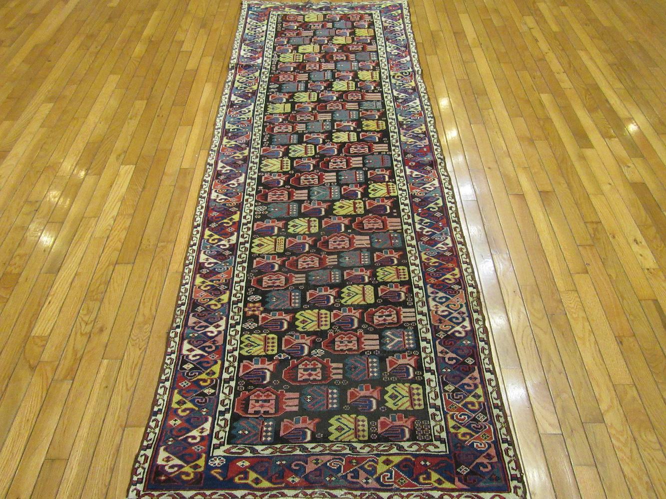 This is an antique hand knotted Caucasian Shirvan rug. It is made with fine wool colored with all natural dyes in a fine tight weave. The rug has a very unique all over geometric design in rich colors. It measures 3' x 8' 6'' and in great condition.