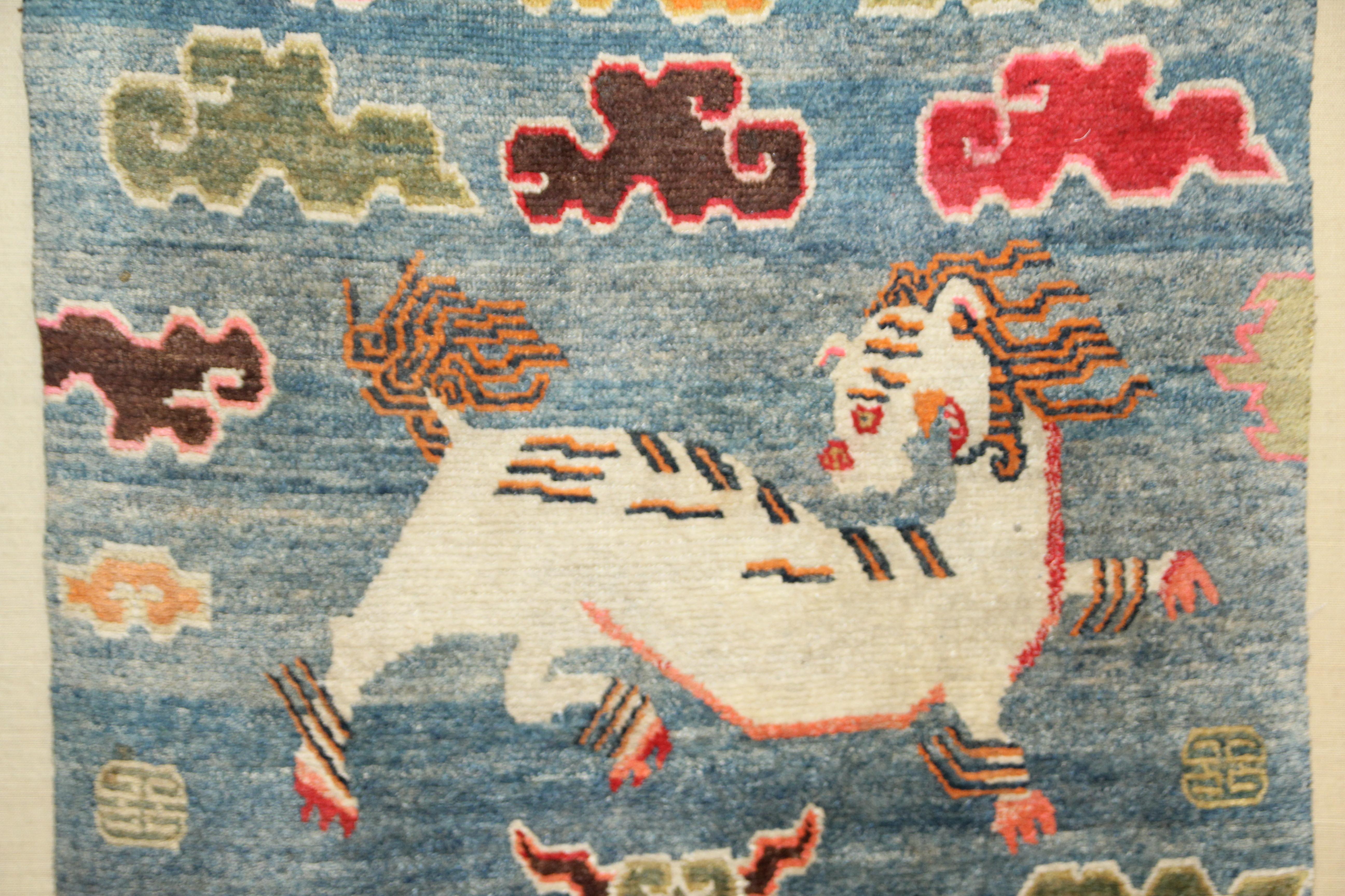 FINE & RARE ANTIQUE TIBETAN CARPET WITH SNOW LEOPARDS AMONGST RUYI CLOUD 

The white snow leopards (a symbol of the power of perception, intuition, determination, experience, self-reliance, and balance) in mirror image with their heads turning