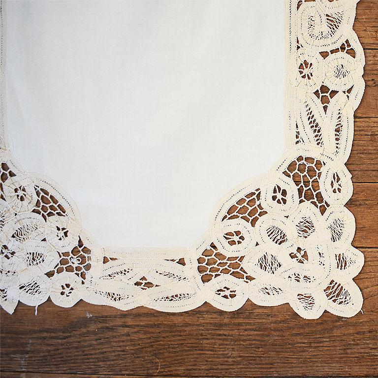 A beautiful handmade lace cream table runner. Created from linen, the piece is framed by hand-made floral motif lace in a complimentary cream hue. A great way to add a touch of elegance to your next dinner party.

Measures: 83