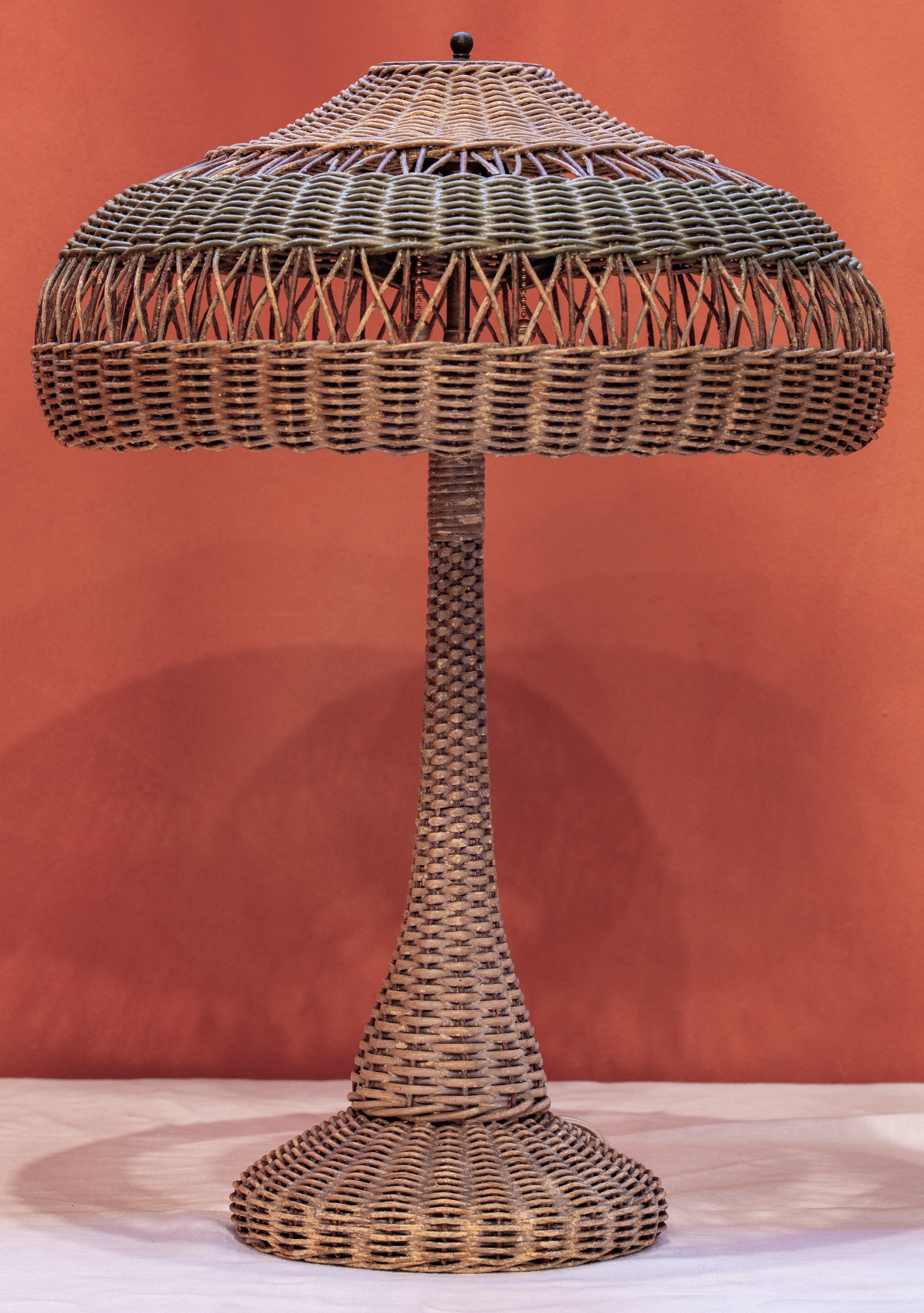 Arts & Crafts style rattan table lamp with original painting that has been slightly retouched. Likely a Heywood Wakefield creation, this wicker lamp exemplifies the innovative but also timeless principles of Arts & Crafts style. Woven wicker or