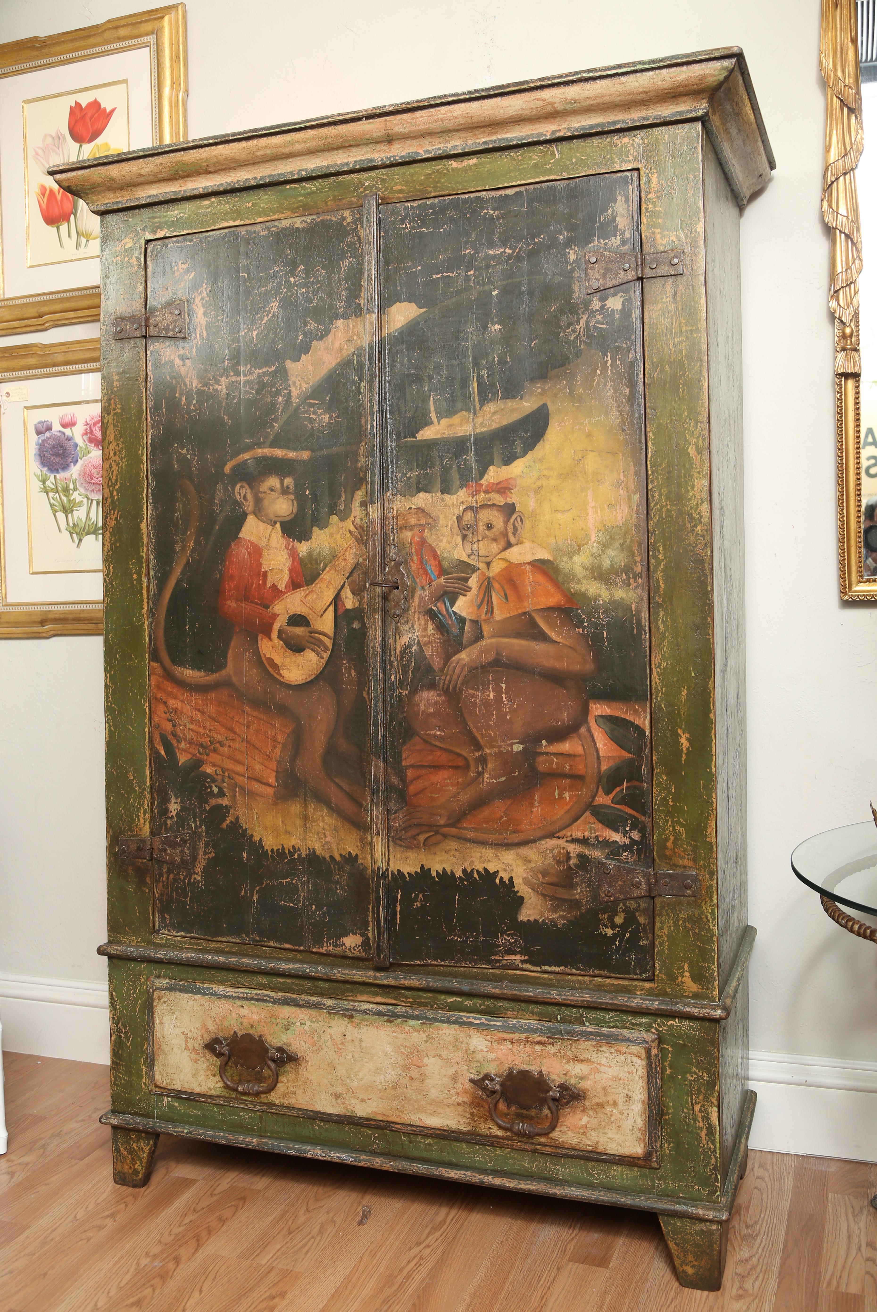 Hand painted two-door cupboard with two monkey's courting.
Three inner shelves and one large drawer at bottom.