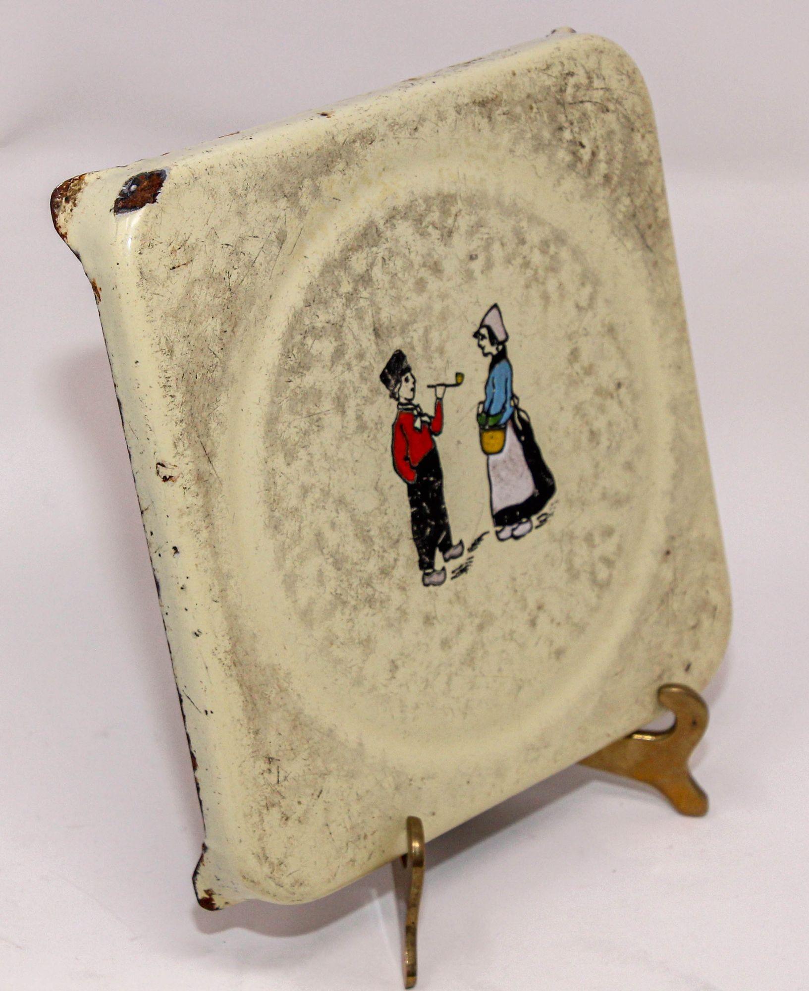 Antique early 20th century Hand Painted Dutch Theme Enamelware Metal circa 1920's.
Hand-painted decorative antique Dutch scene metalware hand made In North Europe, Netherlands, or Germany featuring a Dutch Man and Women. 
Antique pressed square