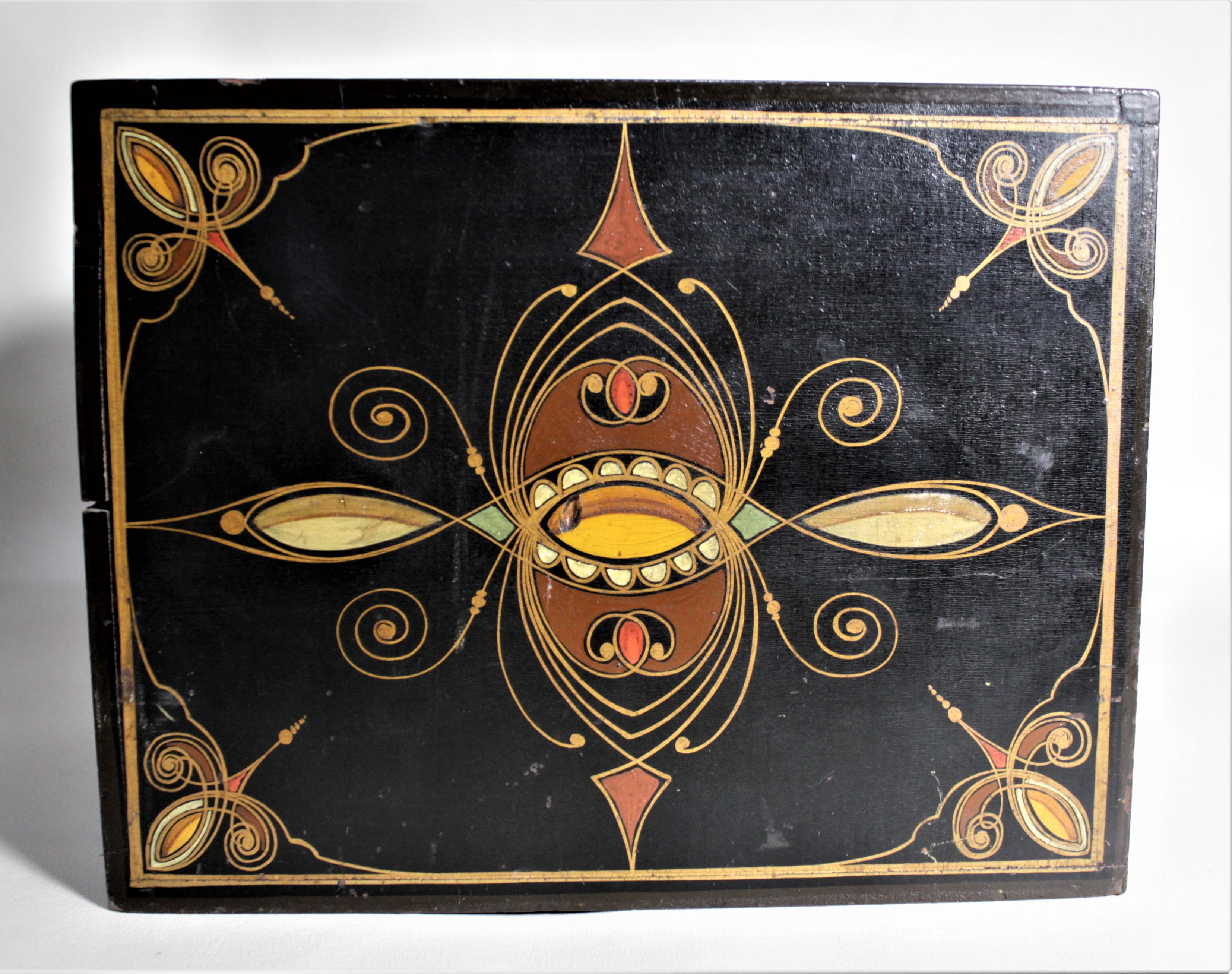 This antique four drawer wooden jewelry or decorative box is unmarked, but believed to date to the early 20th century. The top and sides of the box are ornately painted with borders and a swirled motif in red, green, and gold on a gloss black