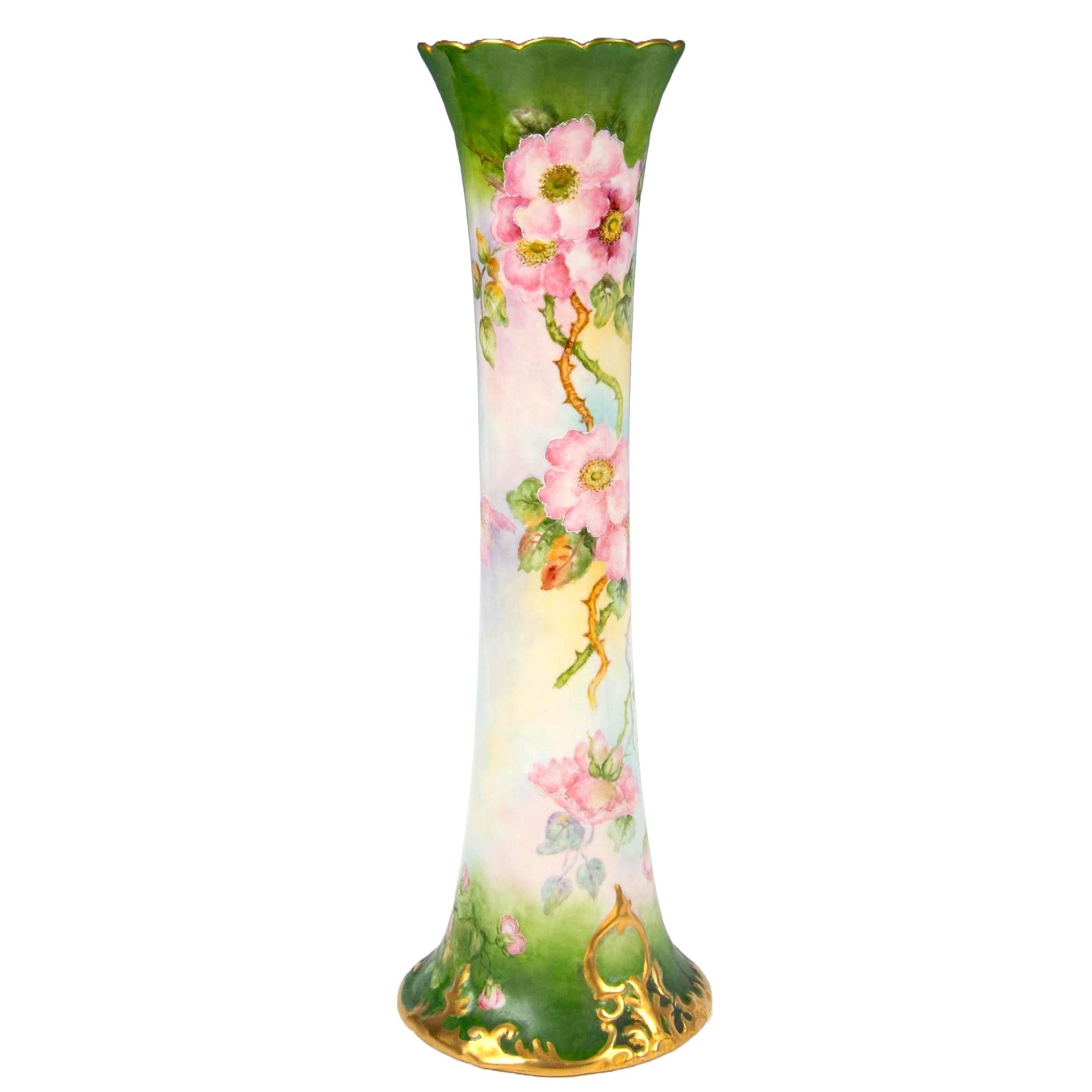Step into the enchanting world of antique elegance with our stunning Hand-Painted & Gilt Decorated Tall Porcelain Rose Vase. This exquisite piece is a testament to timeless beauty, adorned with meticulously hand-painted floral details in lush green