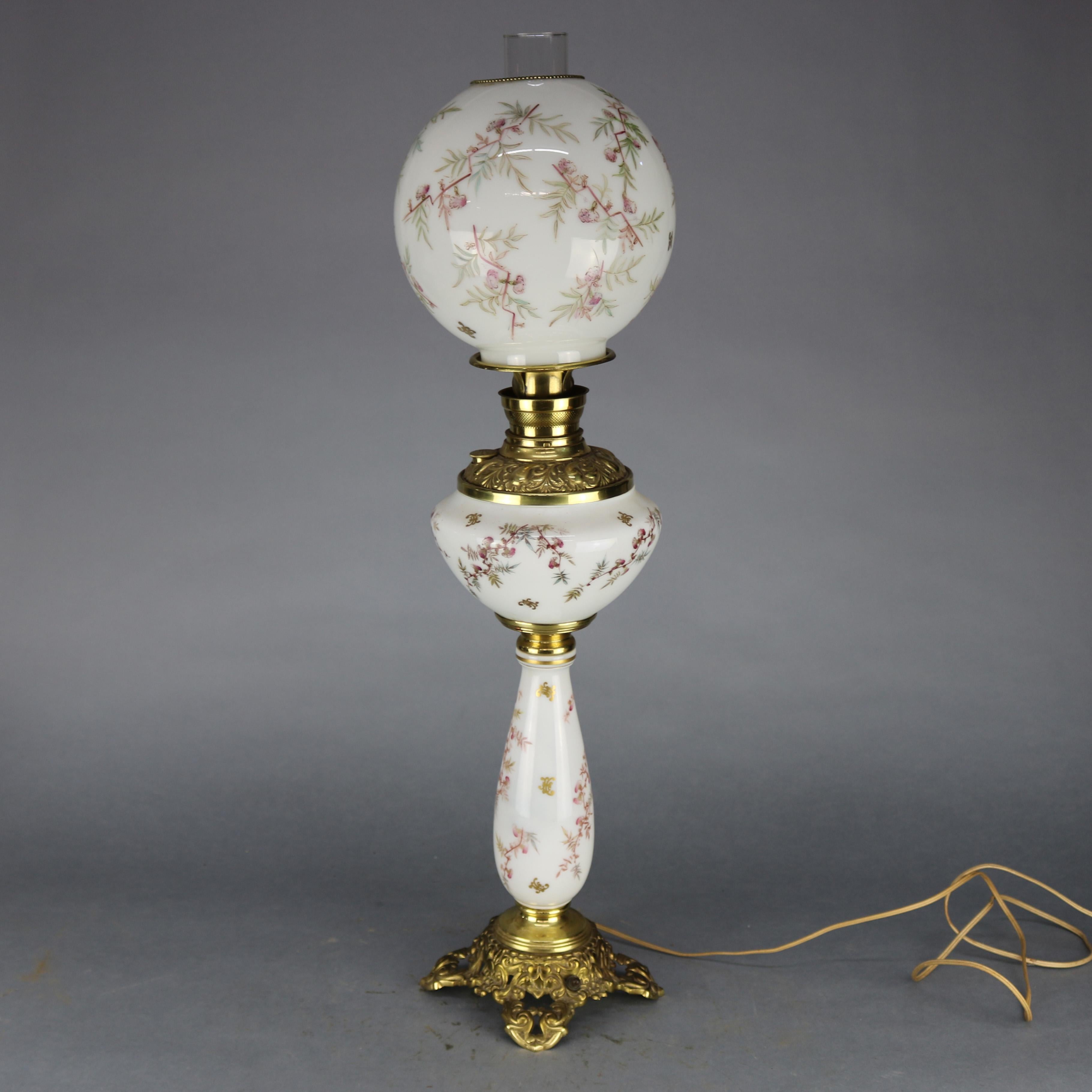 An antique gone with the wind (GWW) parlor lamp offers glass shand and base with all-over design hand painted detached floral spray, seated on foliate cast base, circa 1890.

Measures: 32