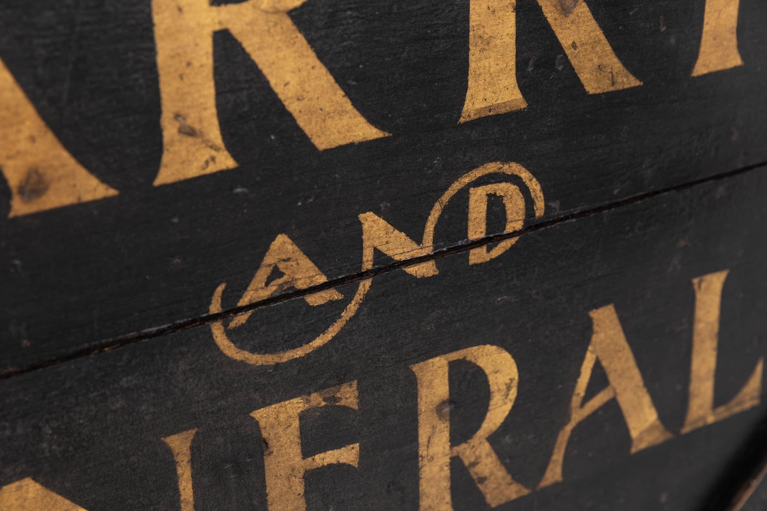 A wonderful hand painted and double sided trade sign for a farrier / blacksmith. c.1900.

Hand painted by a skilled sign-writer in gold type on a black background. Double sided with both sides the same. Ironwork edge banding and decorative scroll