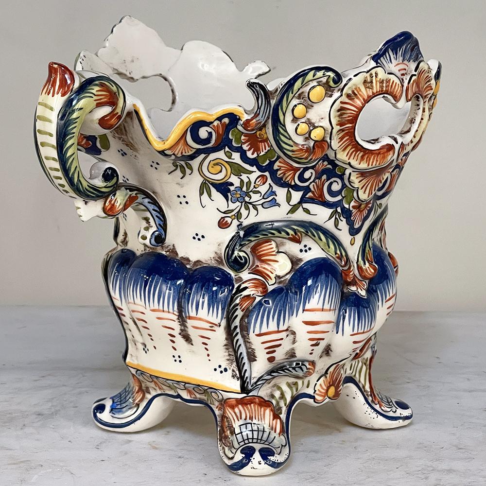 Antique hand-painted jardiniere from Rouen is a vibrantly colored, fancifully styled vase that adds visual delight to any room, regardless of whether one has placed fresh flowers in it or not! The naturalistic scrollwork of the design features four