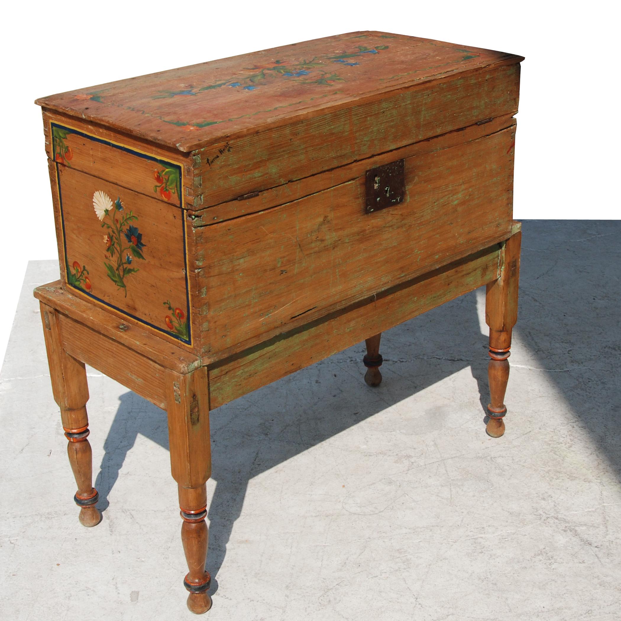 Antique, hand painted Mexican wedding or hope chest on stand

Features beautiful hand painted accents throughout, as well as a locking mechanism. Locking mechanism appears to be a more recent addition to this piece.