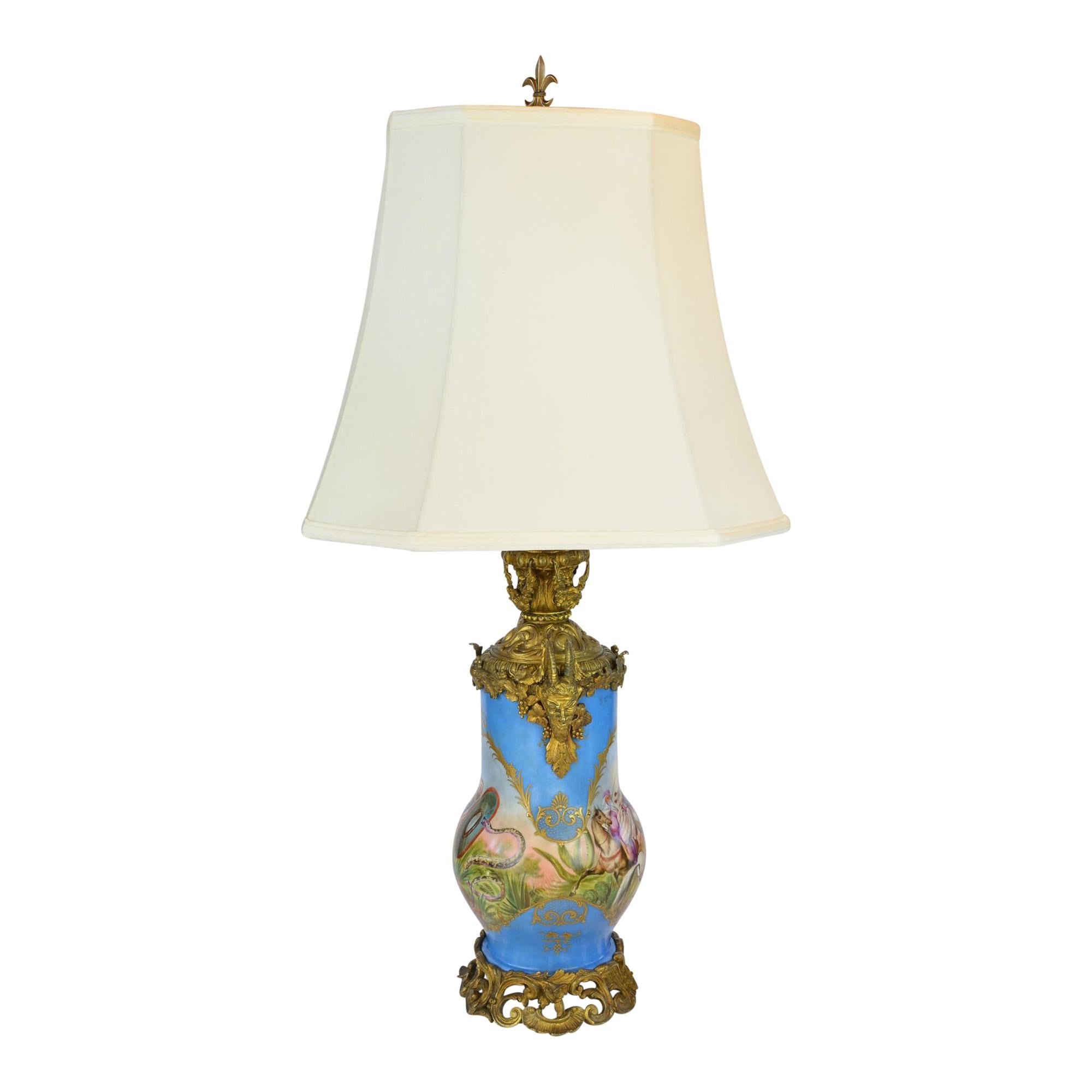 We refer to this lamp as the story lamp. The hand painted scenes show a scene of the invasion from by the Moors while the opposite side depicts a man engaged in a battle with a snake. The porcelain lamp also features unique hand heavily detailed