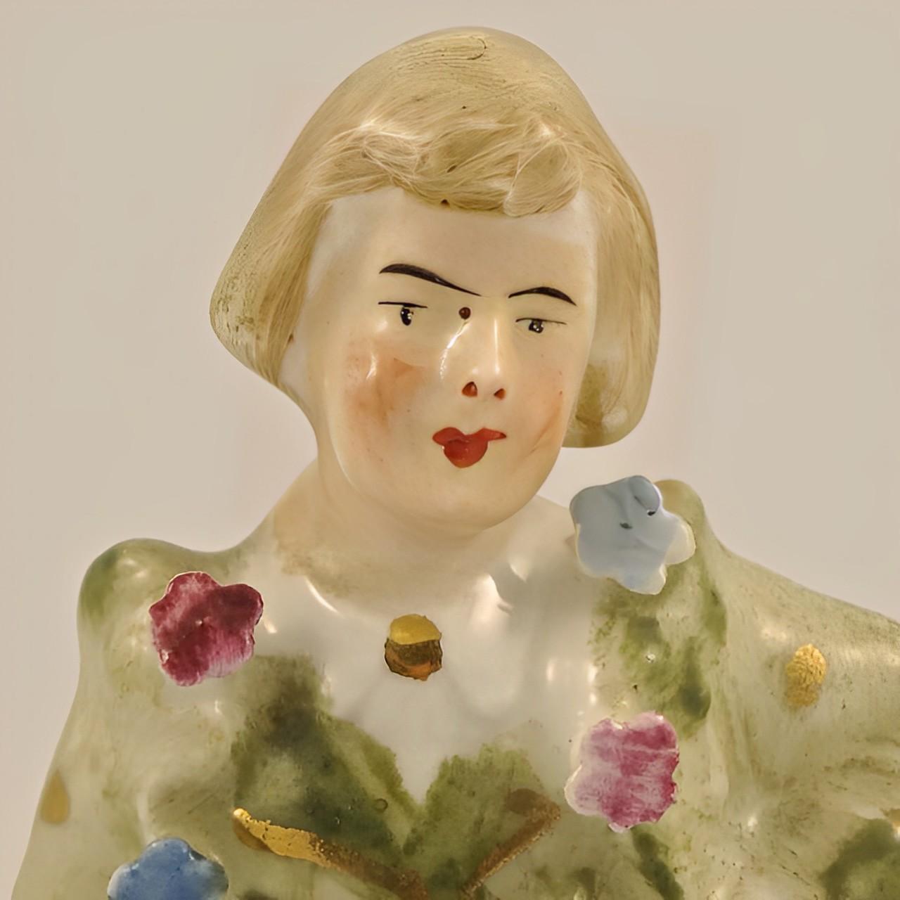 Lovely antique hand painted porcelain man figurine, with blue and pink flowers and gold detail. This antique figurine is in very good condition.

He would look wonderful in any room.