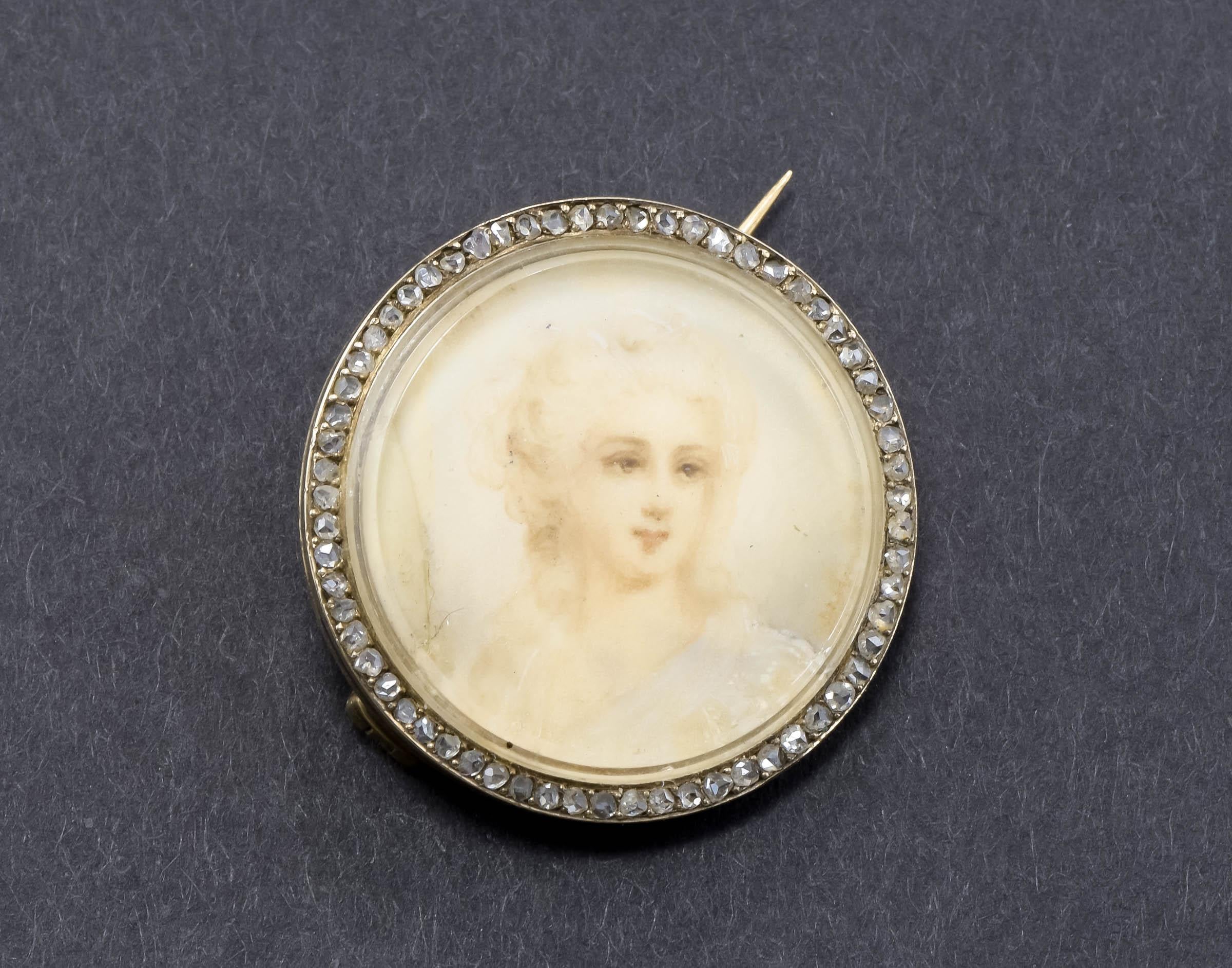 I'm delighted to offer a very lovely antique portrait miniature brooch, surrounded by glittering rose cut diamonds.

Crafted of gold testing around 15K, the round brooch features a hand painted portrait of a Georgian woman with kind brown eyes