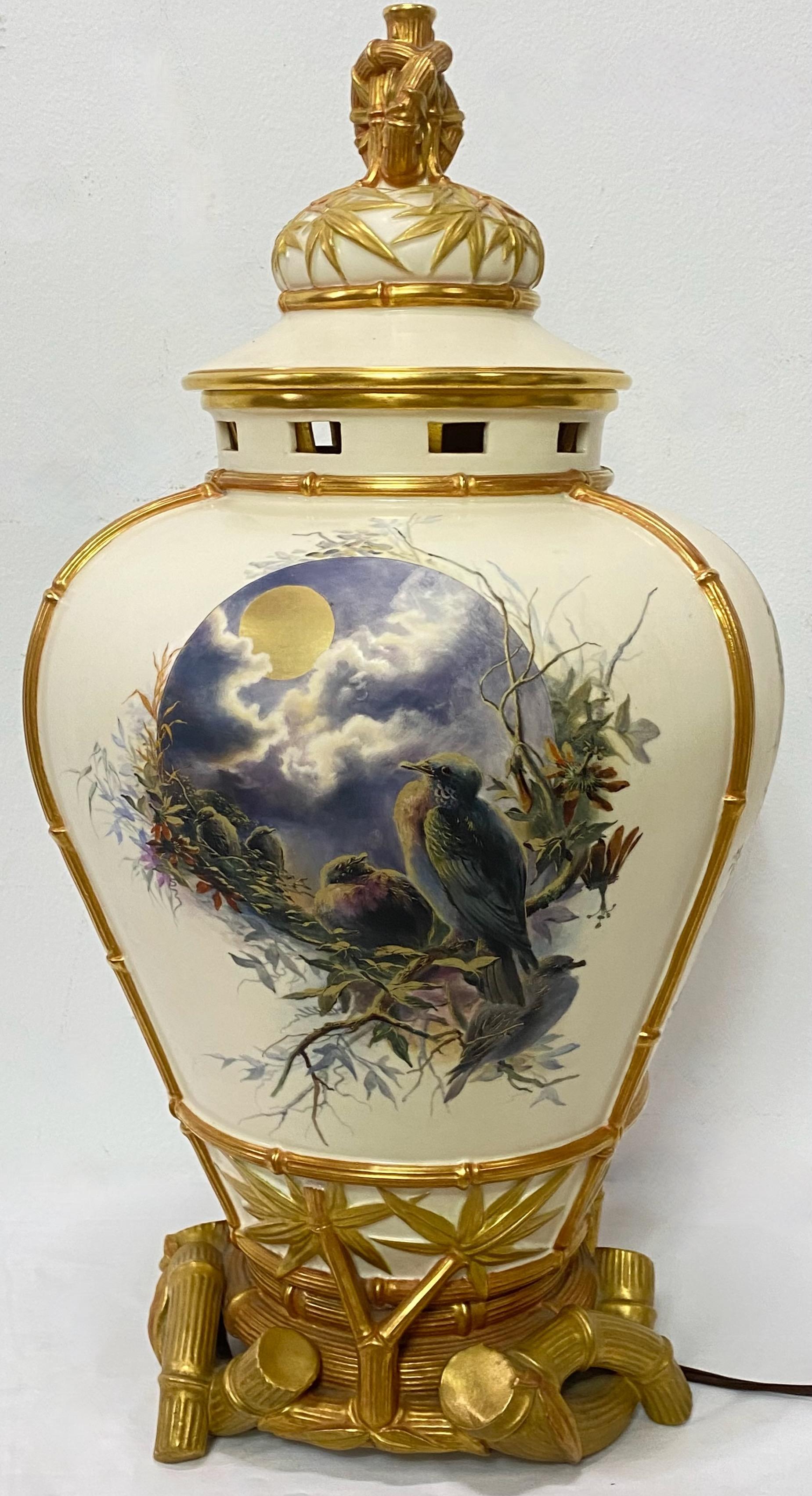 An unusual grand scale antique English Royal Worcester porcelain hand painted urn shape vessel, now electrified. Finely painted and fabulously decorated with birds and flowers and gilt detail.
England, late 19th century.
Recently re-wired.
  