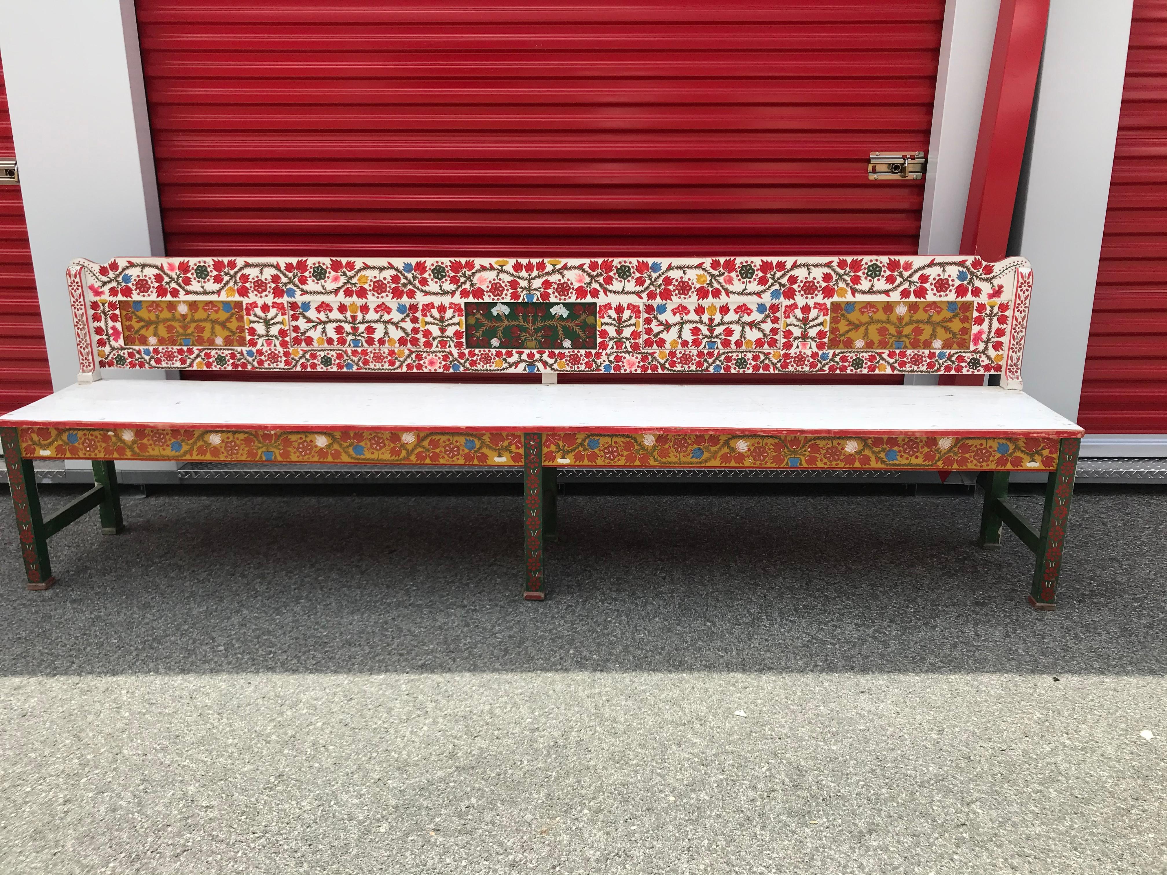 An absolutely striking antique Swedish bench with beautifully hand painted floral designs against the signature red/white flag. This Swedish bench not only celebrates the traditional floral display but incorporates functionality with it's long