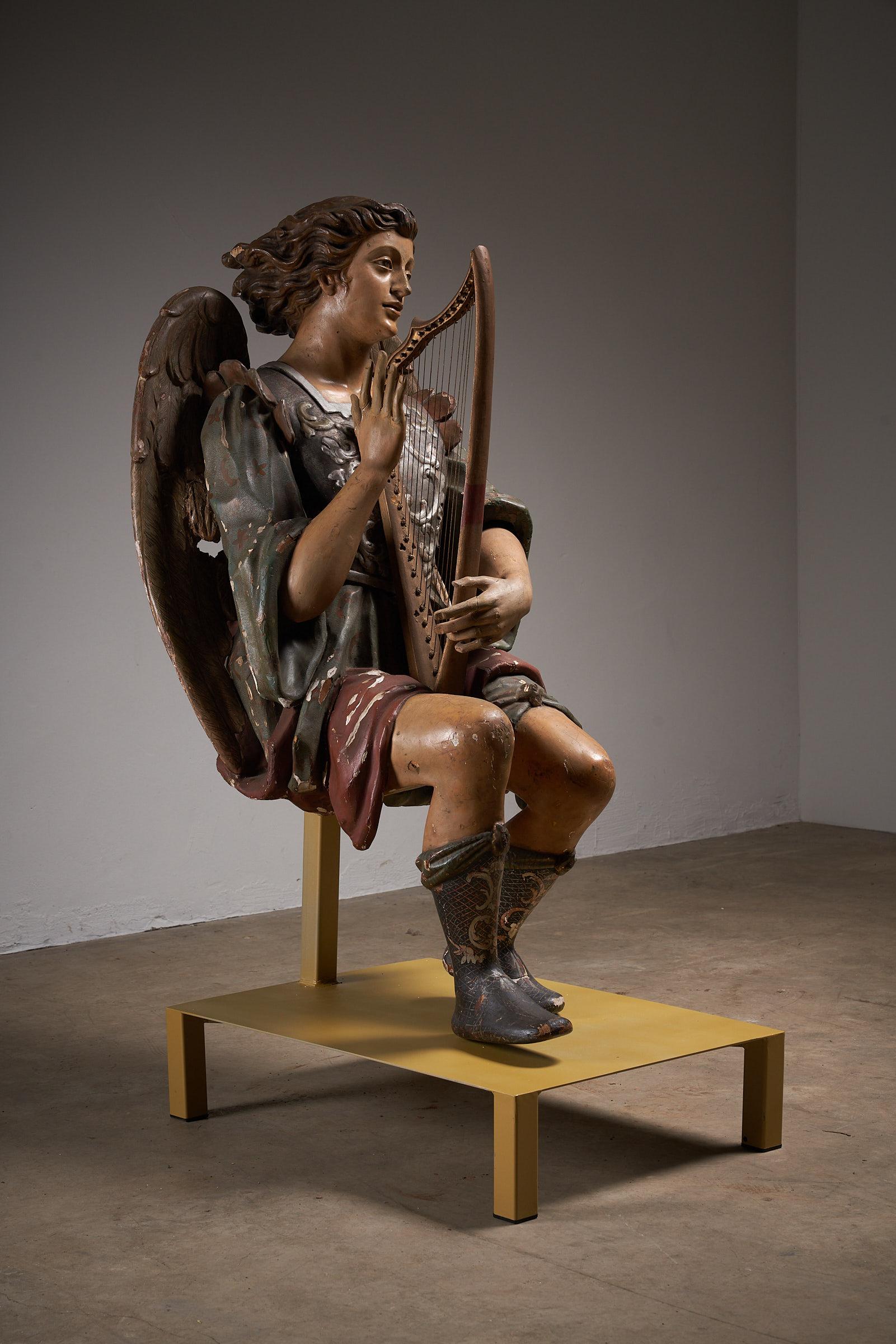 This exquisite antique hand-painted wooden sculpture of an angel playing a harp is a stunning example of 19th-century religious art. The angel is beautifully detailed, with a serene expression and delicately carved wings that add to the ethereal