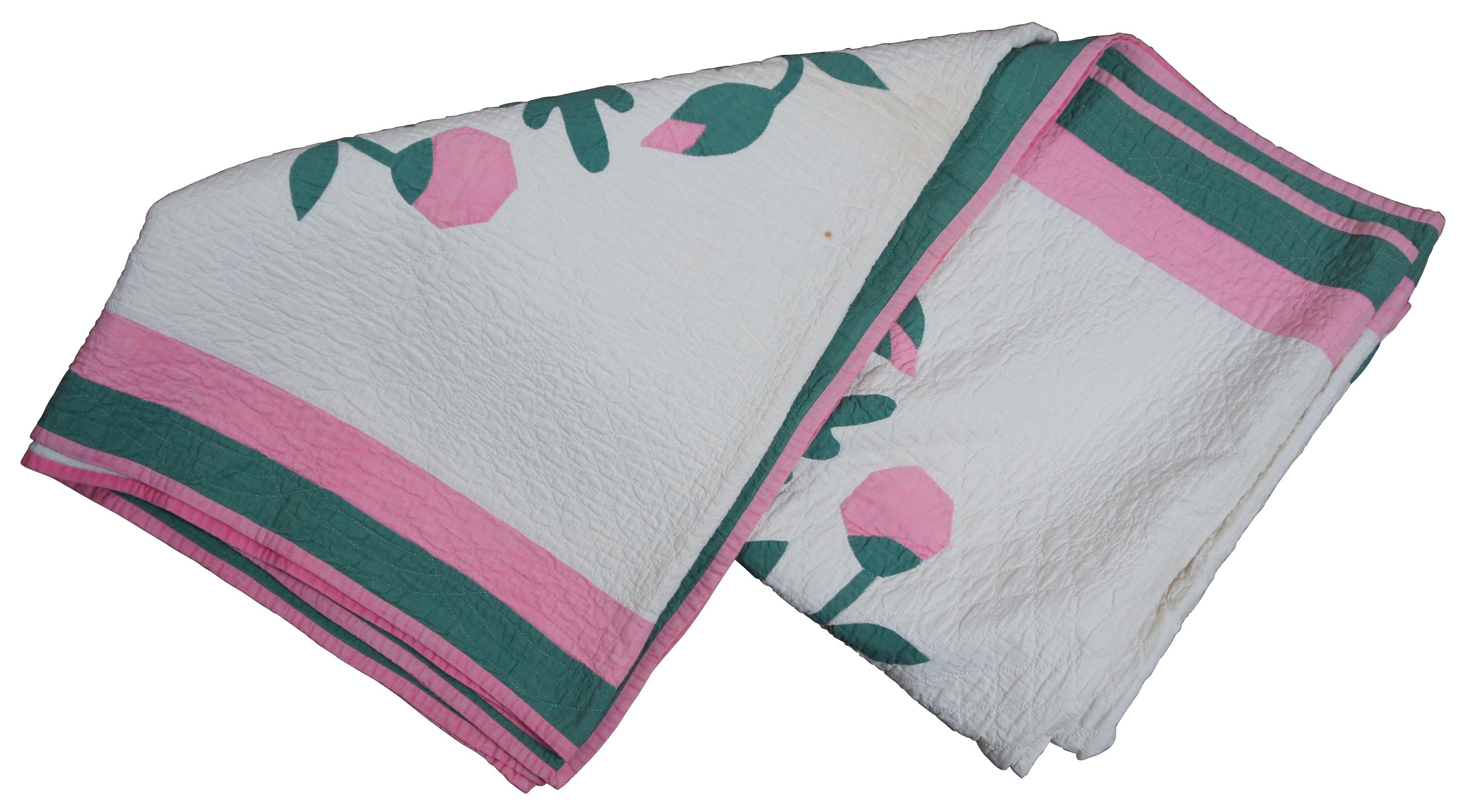 Antique hand stitched quilt or bedspread with pink and green border and a Rose of Sharon type floral motif. Measures: 74 x 78.
 