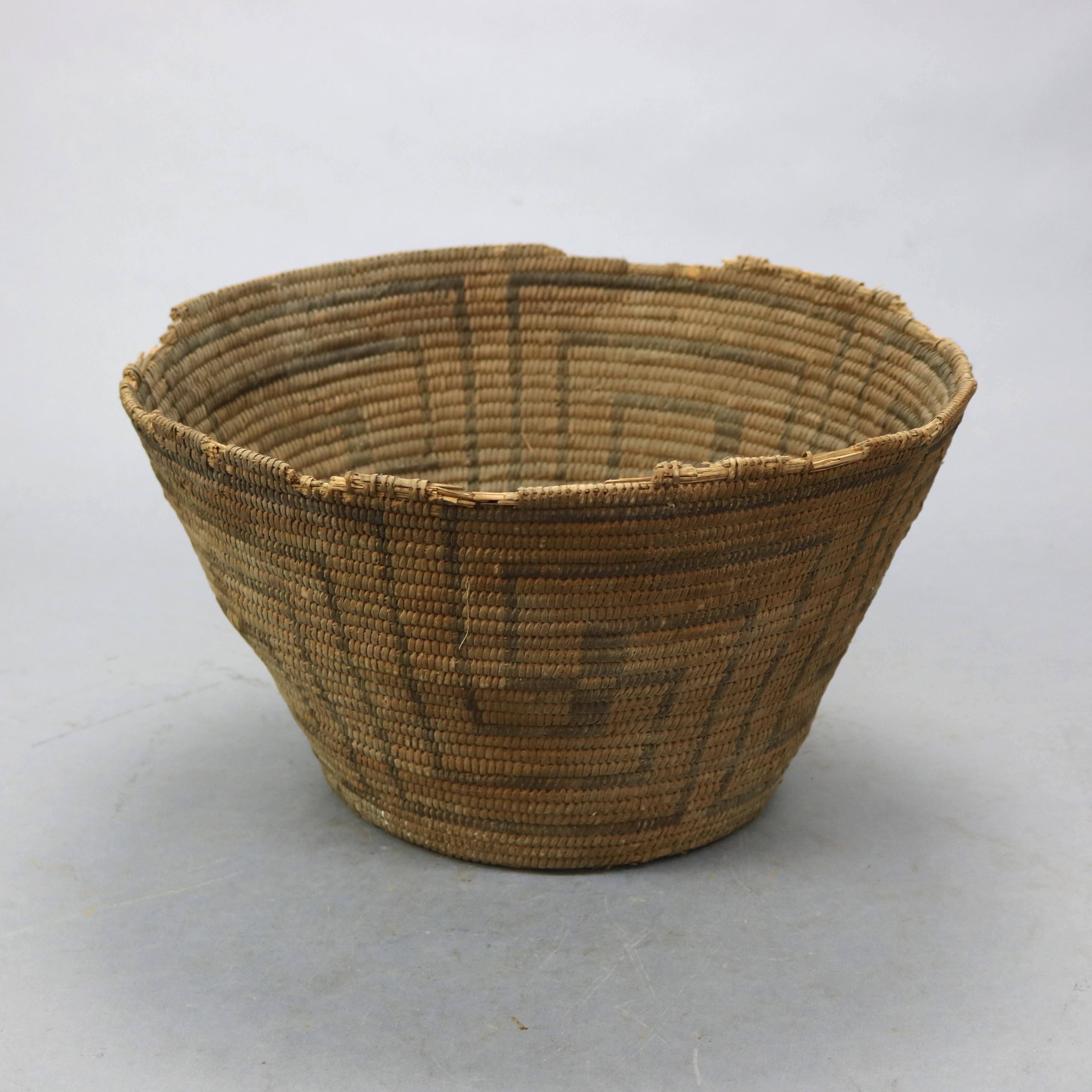 An antique Navajo American Indian basket offers hand woven reed construction in flared form with repeating geometric Whirling Log good luck design , circa 1920

Measures - 8.25''H x 12.5''W x 12.5''D.