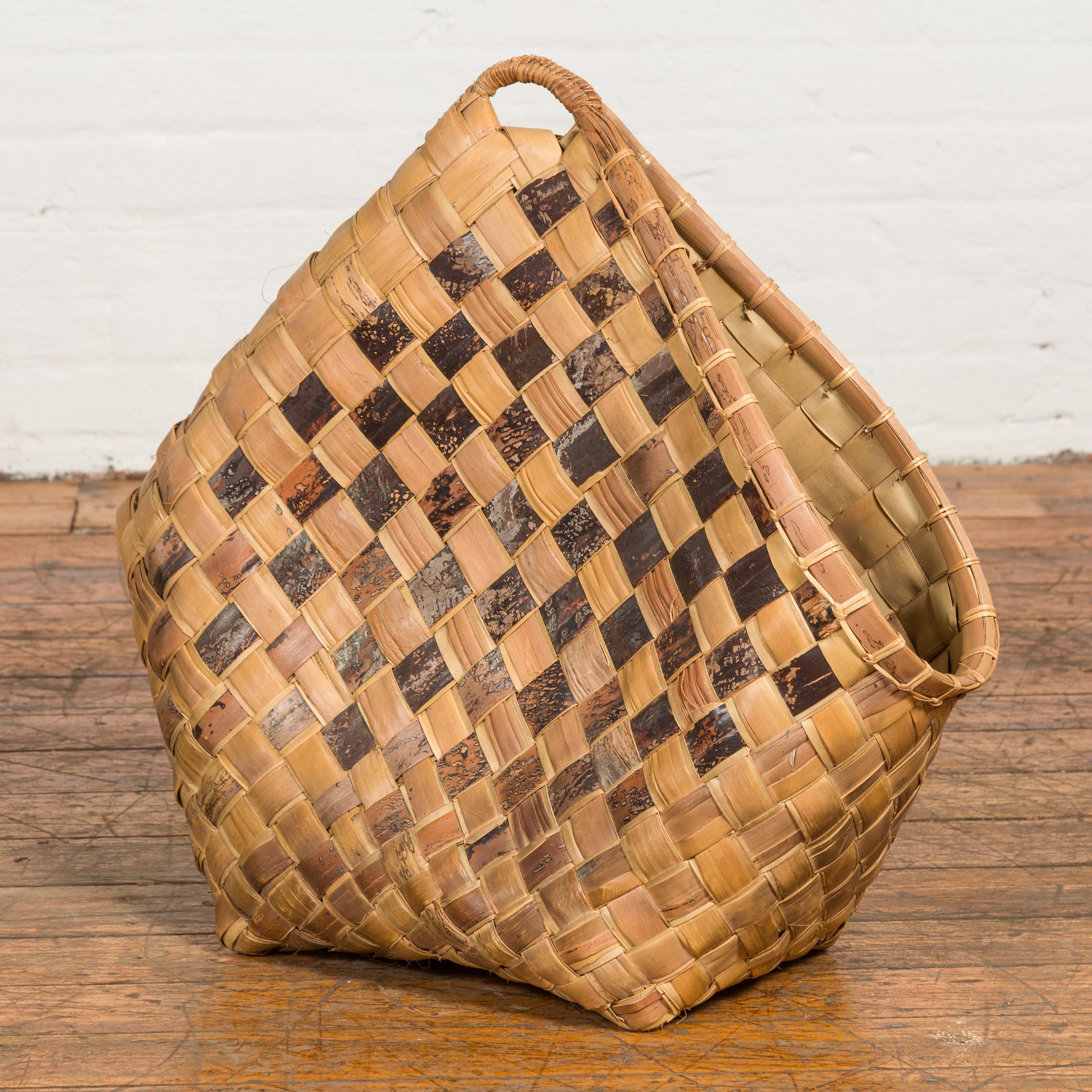 A hand woven karagumoy Filipino basket from the 19th century, with checkered two-toned structure, side opening and rustic character. Created in the Philippines during the 19th century, this decorative basket could be used as a newspaper or magazine