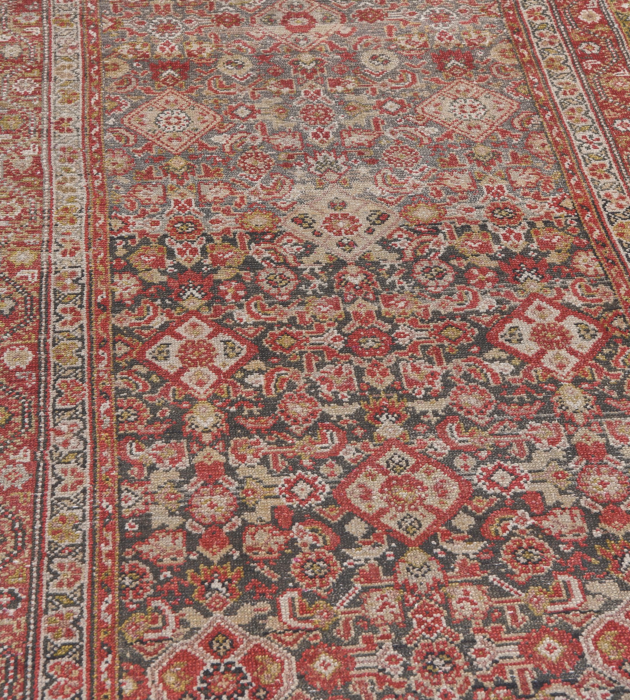This traditional hand-woven Persian Malayer rug has a shaded wheat saffron field with an overall polychrome herati pattern field, in refined pistachio, rust, and cream triple vine stripe border.

Persian Malayer rugs, originating from the Malayer