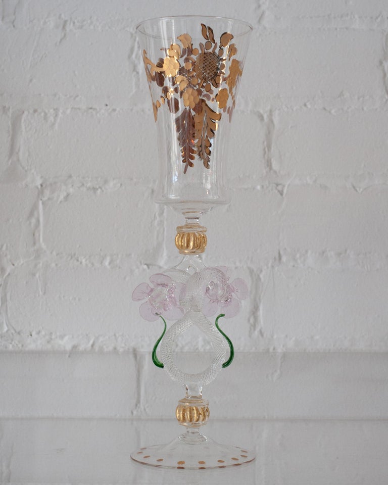 Heighten any table with an antique hand blown Murano glass flute/vase with gold gilding. Delicate and ornate, each glass is its own unique design and color, and no two Murano pieces are exactly the same. These are truly artisanal works, whether used