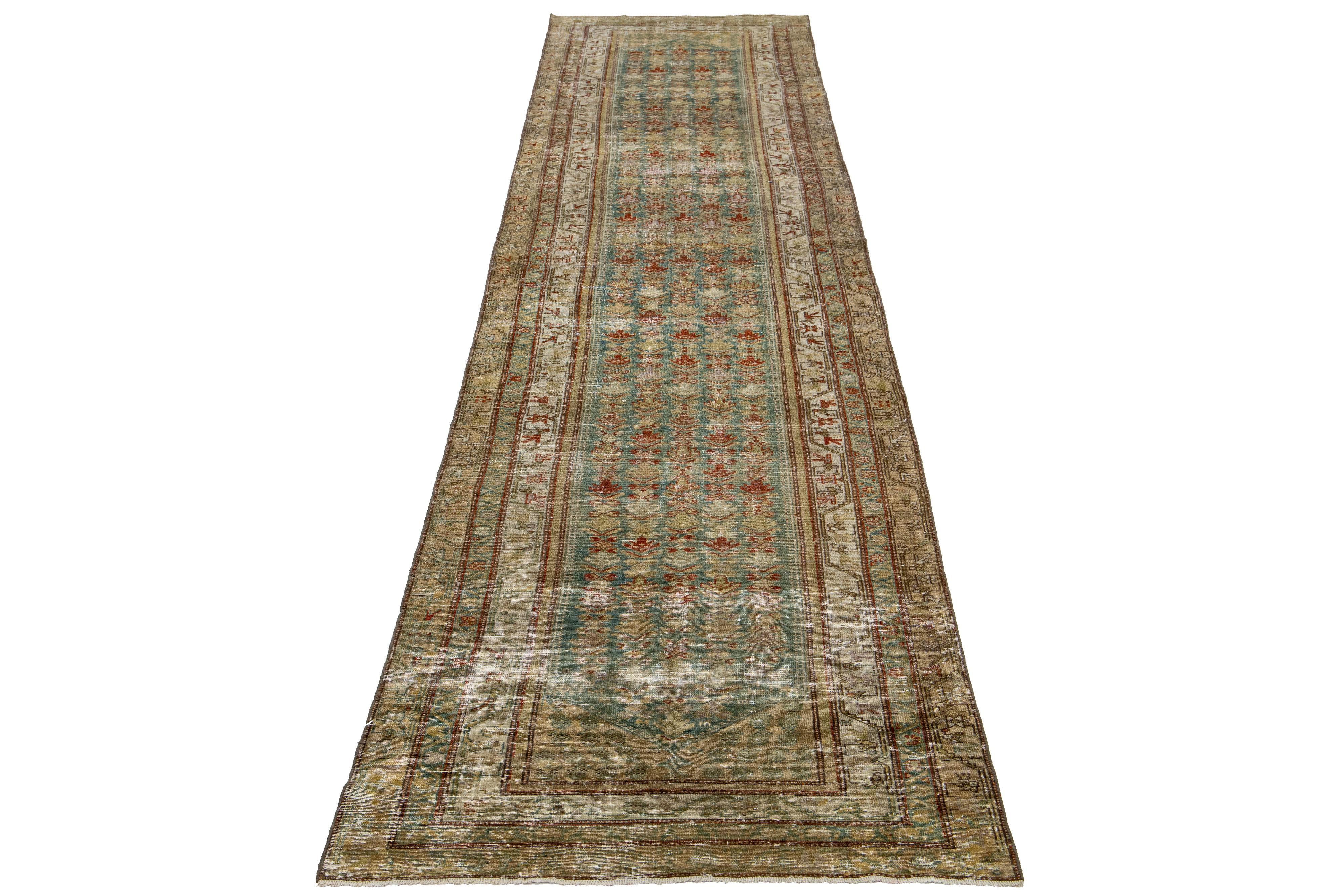 This Persian Malayer wool rug possesses an antique allure. It showcases hand-knotted wool in a teal color field. The tribal pattern is embellished with rust, blue, and green accents.

This rug measures 3'5