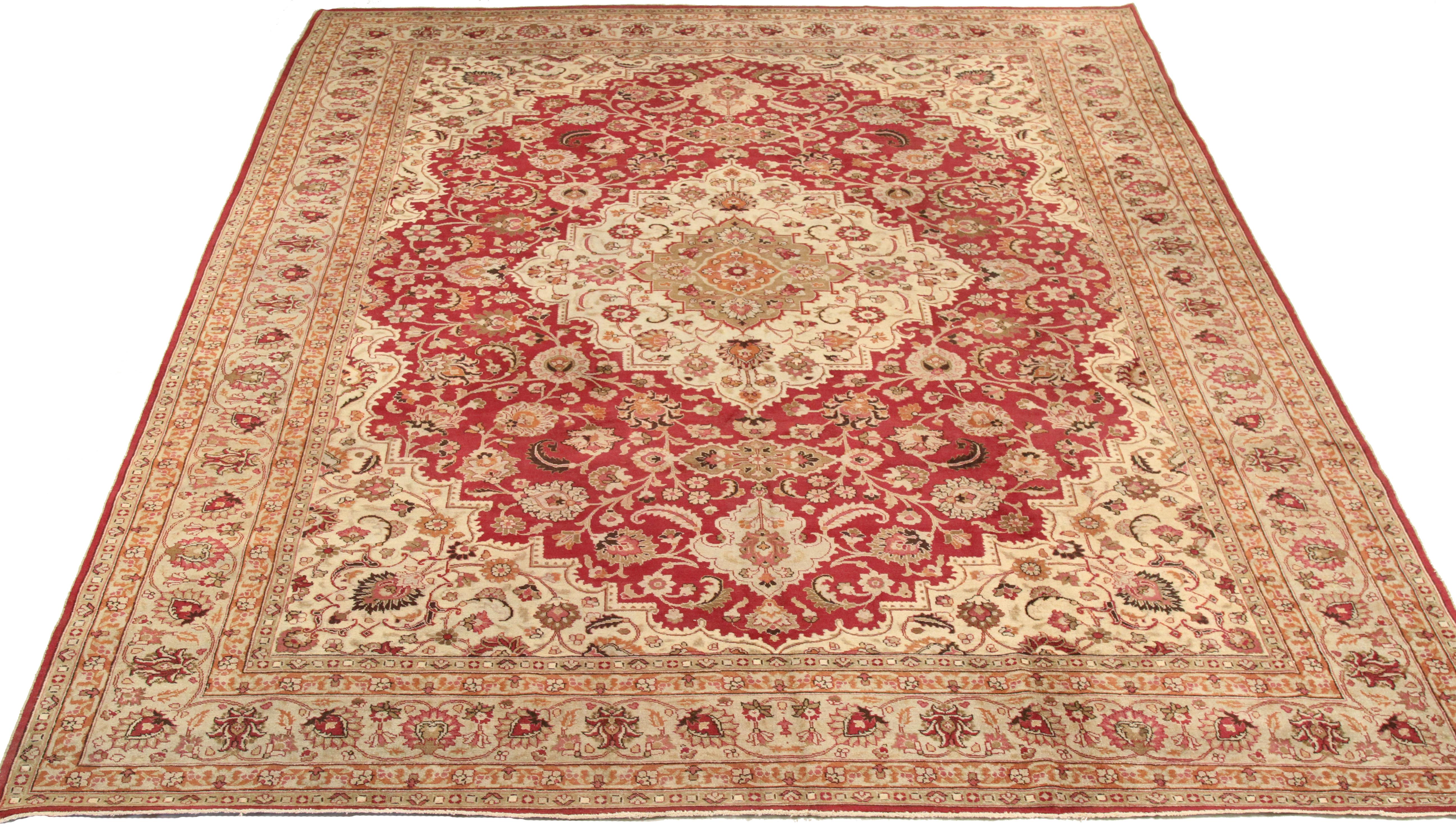 Antique mid-20th century hand knotted Persian area rug made from fine wool and all-natural vegetable dyes that are safe for people and pets. This beautiful piece features intricate floral patterns in various colors which Mashad rugs are known for.